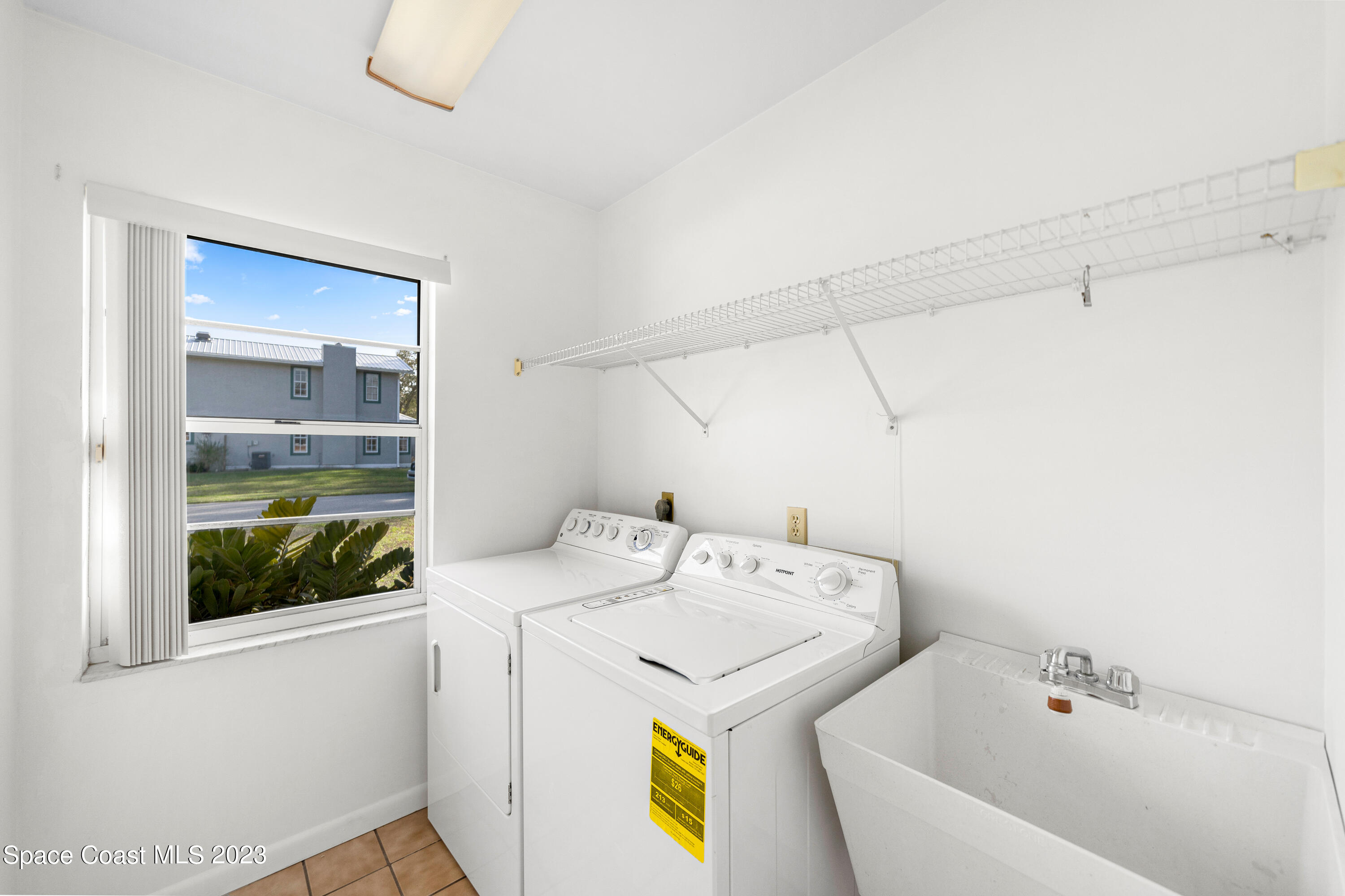 7746 Mango Grove Avenue Melbourne, FL 32904 - Photo 16 of 21 a utility room with dryer and washer