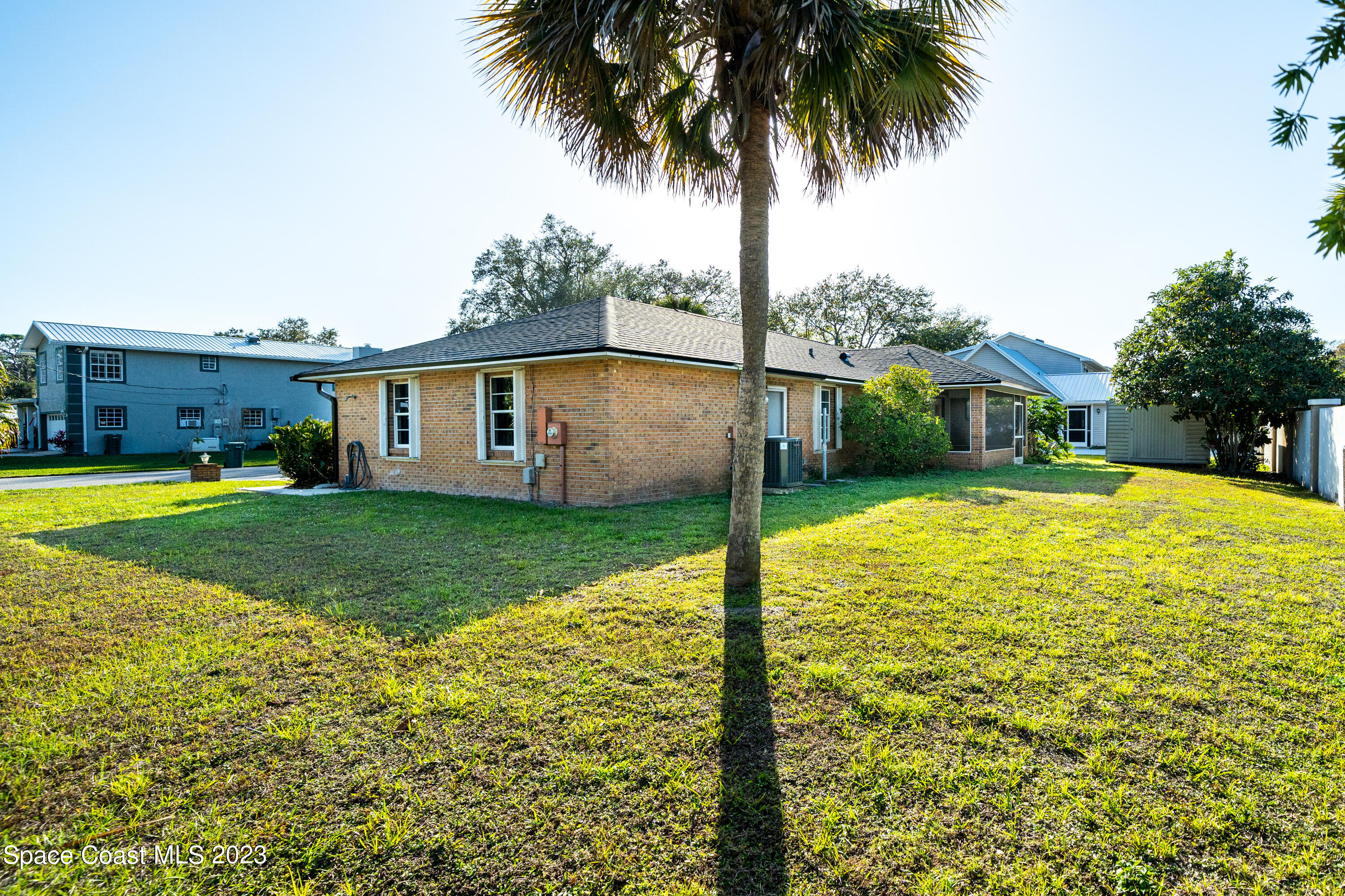 7746 Mango Grove Avenue Melbourne, FL 32904 - Photo 20 of 21 a view of a house with a swimming pool