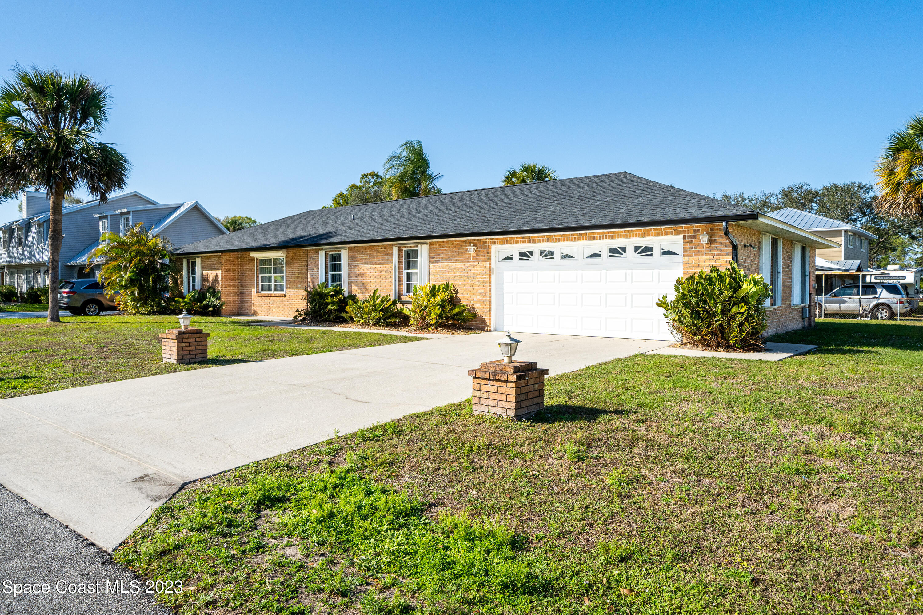 7746 Mango Grove Avenue Melbourne, FL 32904 - Photo 2 of 21 a front view of a house with garden
