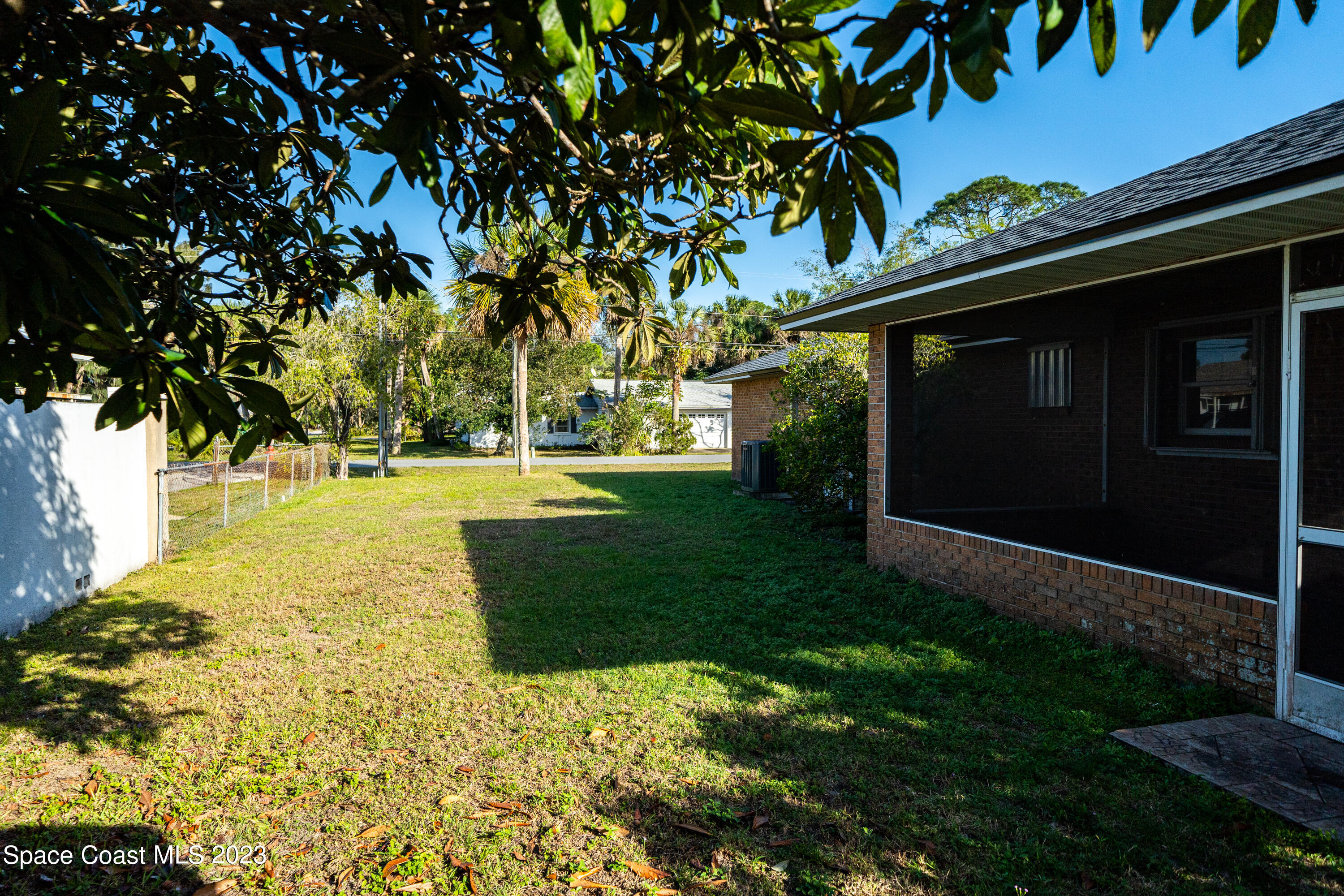 7746 Mango Grove Avenue Melbourne, FL 32904 - Photo 21 of 21 a backyard of a house with lots of green space