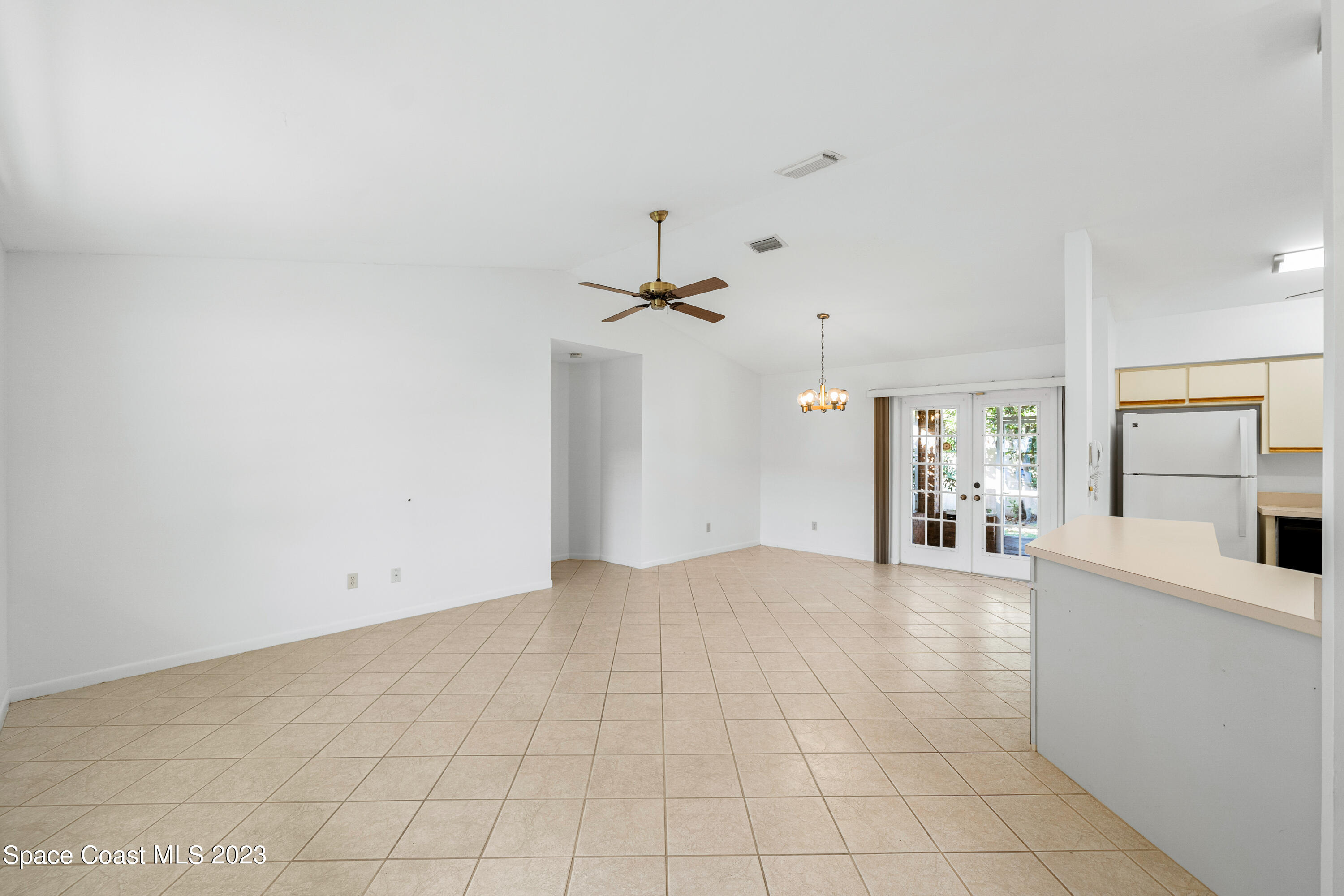 7746 Mango Grove Avenue Melbourne, FL 32904 - Photo 4 of 21 a view of a kitchen with furniture and a ceiling fan