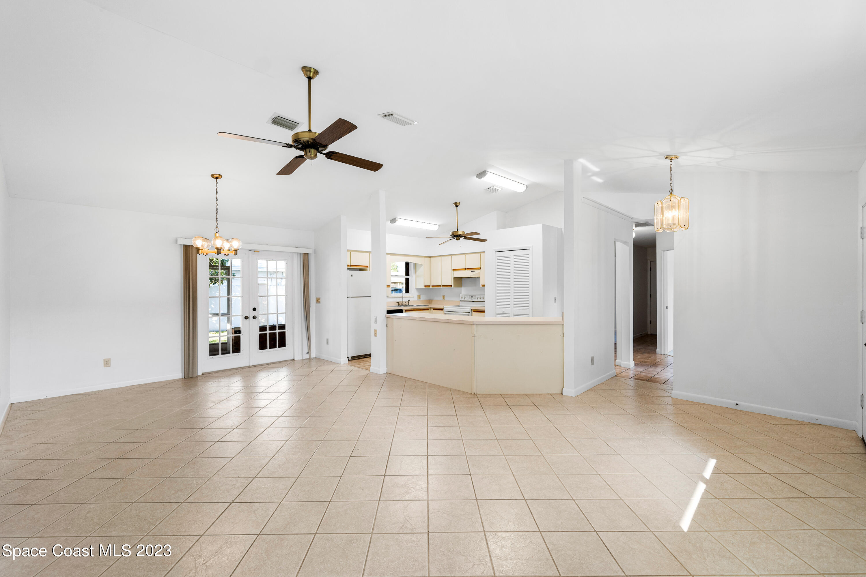 7746 Mango Grove Avenue Melbourne, FL 32904 - Photo 5 of 21 a view of a kitchen with furniture and a ceiling fan