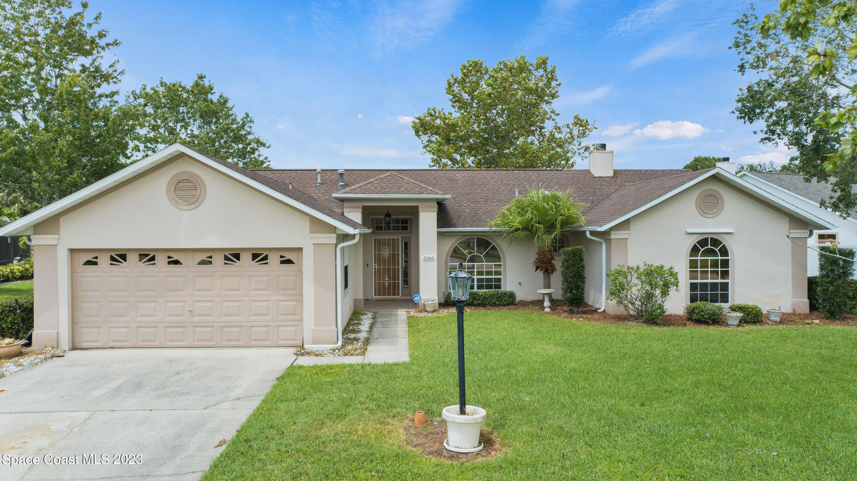 a front view of house with yard and green space