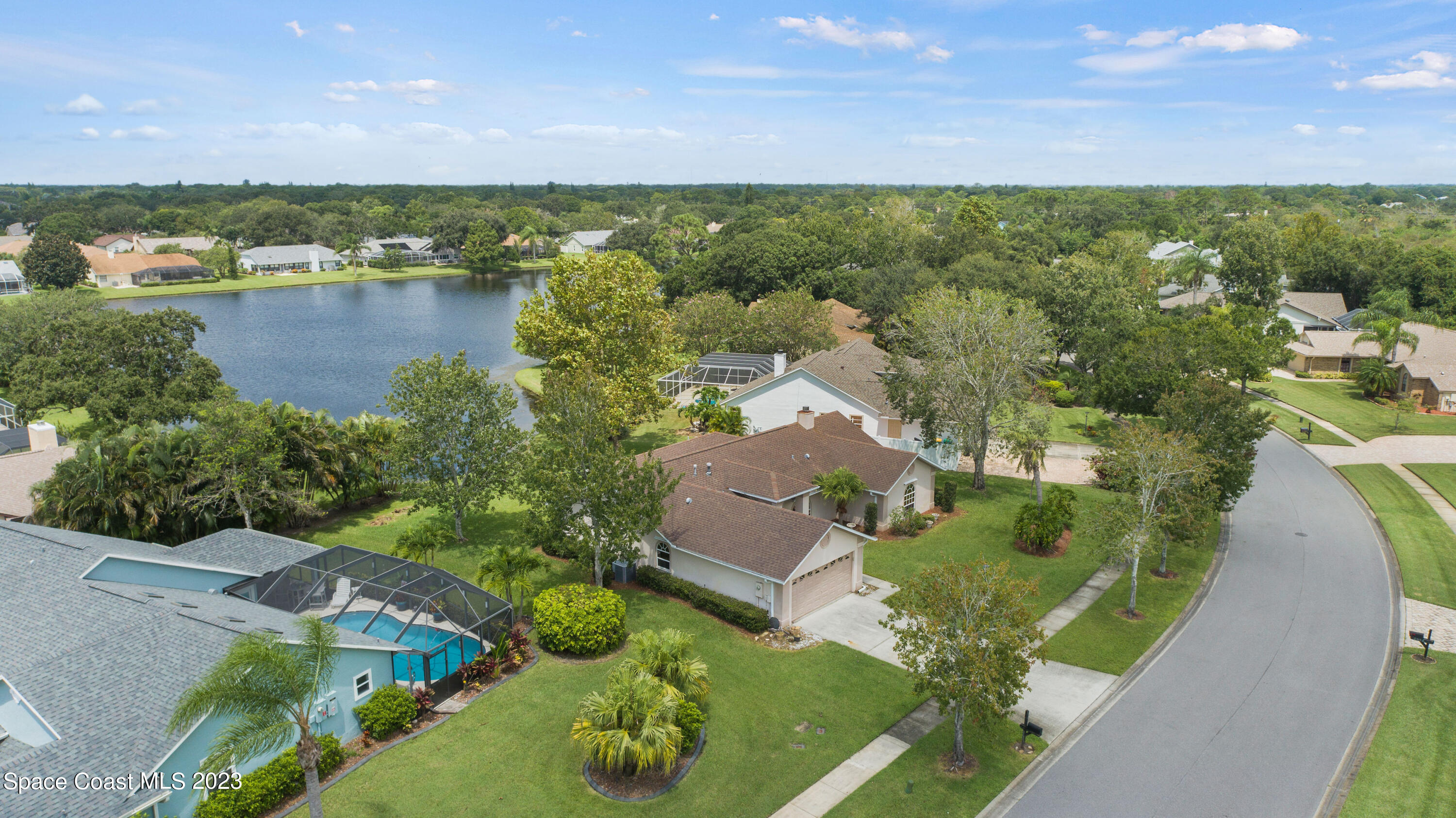 3360 Holly Springs Road Melbourne, FL 32934 - Photo 14 of 42 an aerial view of residential houses with outdoor space and lake view