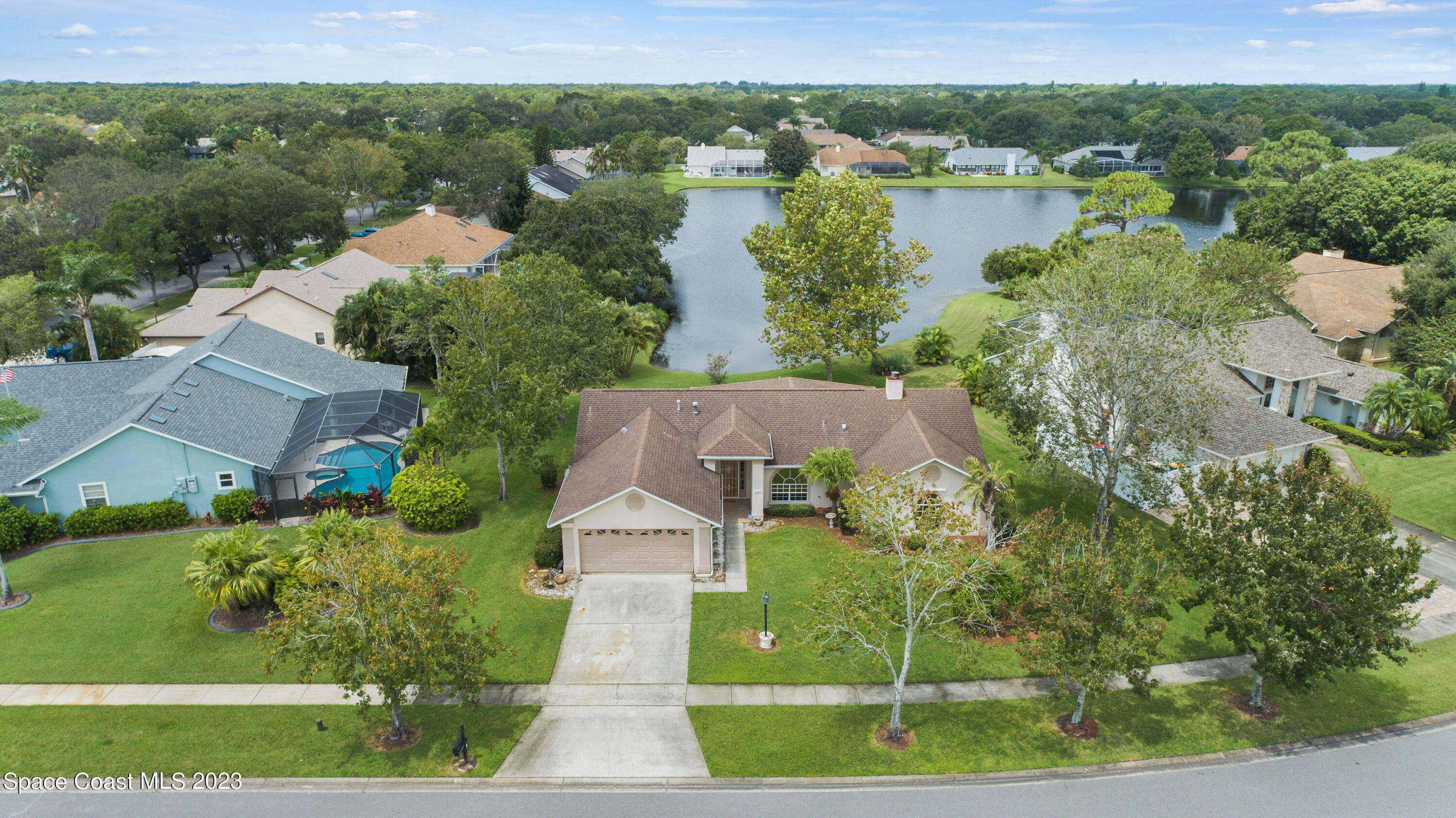 3360 Holly Springs Road Melbourne, FL 32934 - Photo 15 of 42 an aerial view of a house with outdoor space and lake view