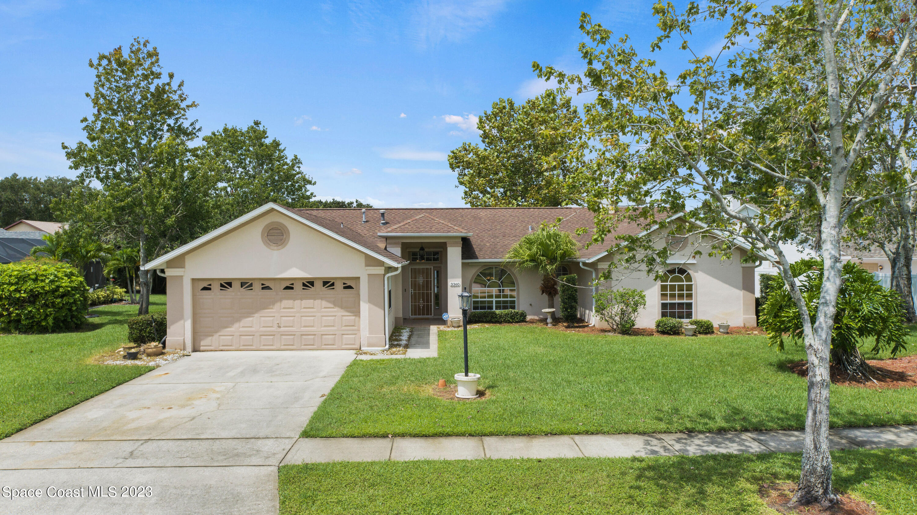 3360 Holly Springs Road Melbourne, FL 32934 - Photo 16 of 42 a front view of a house with a yard