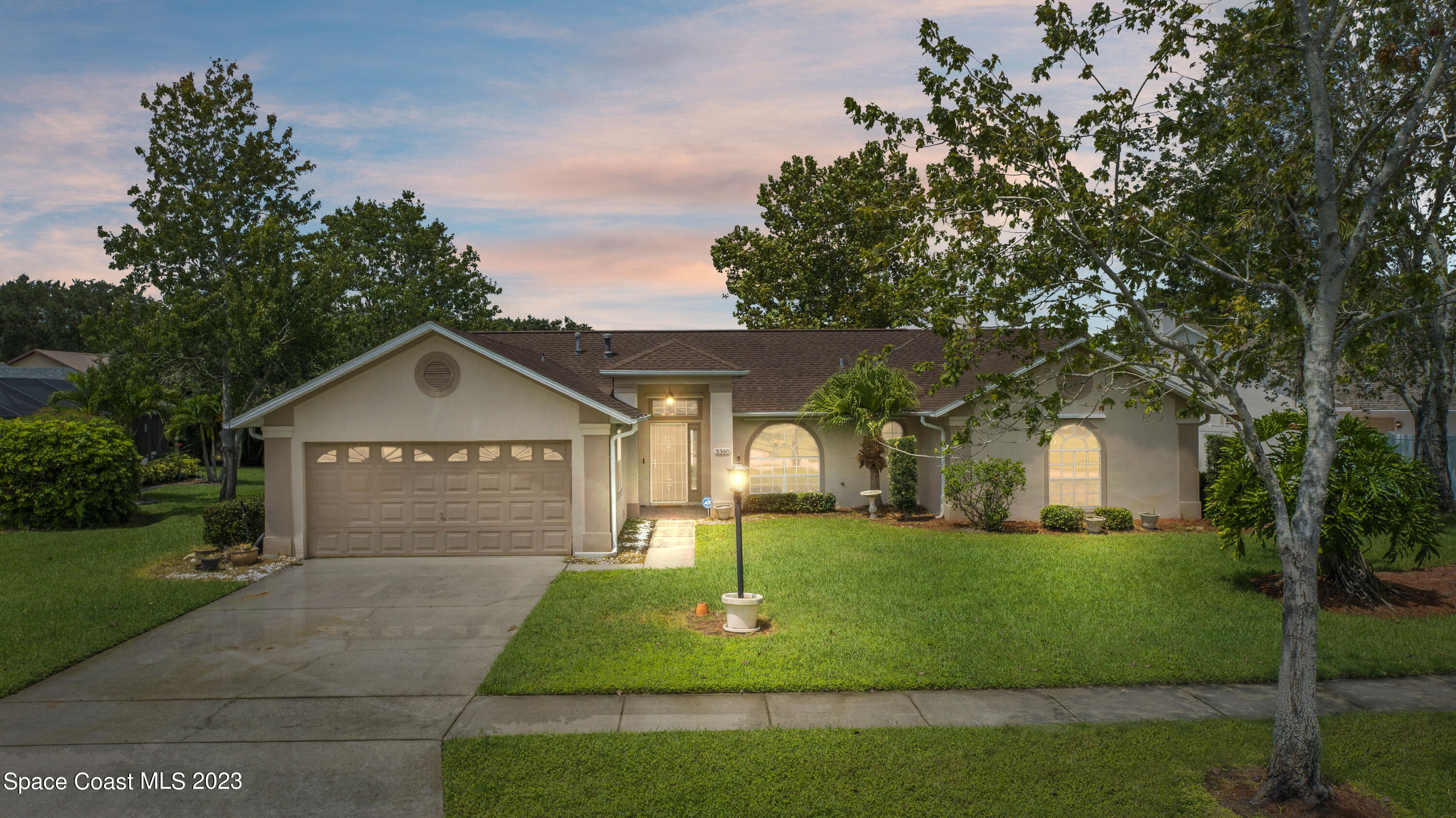 3360 Holly Springs Road Melbourne, FL 32934 - Photo 17 of 42 a front view of a house with a yard