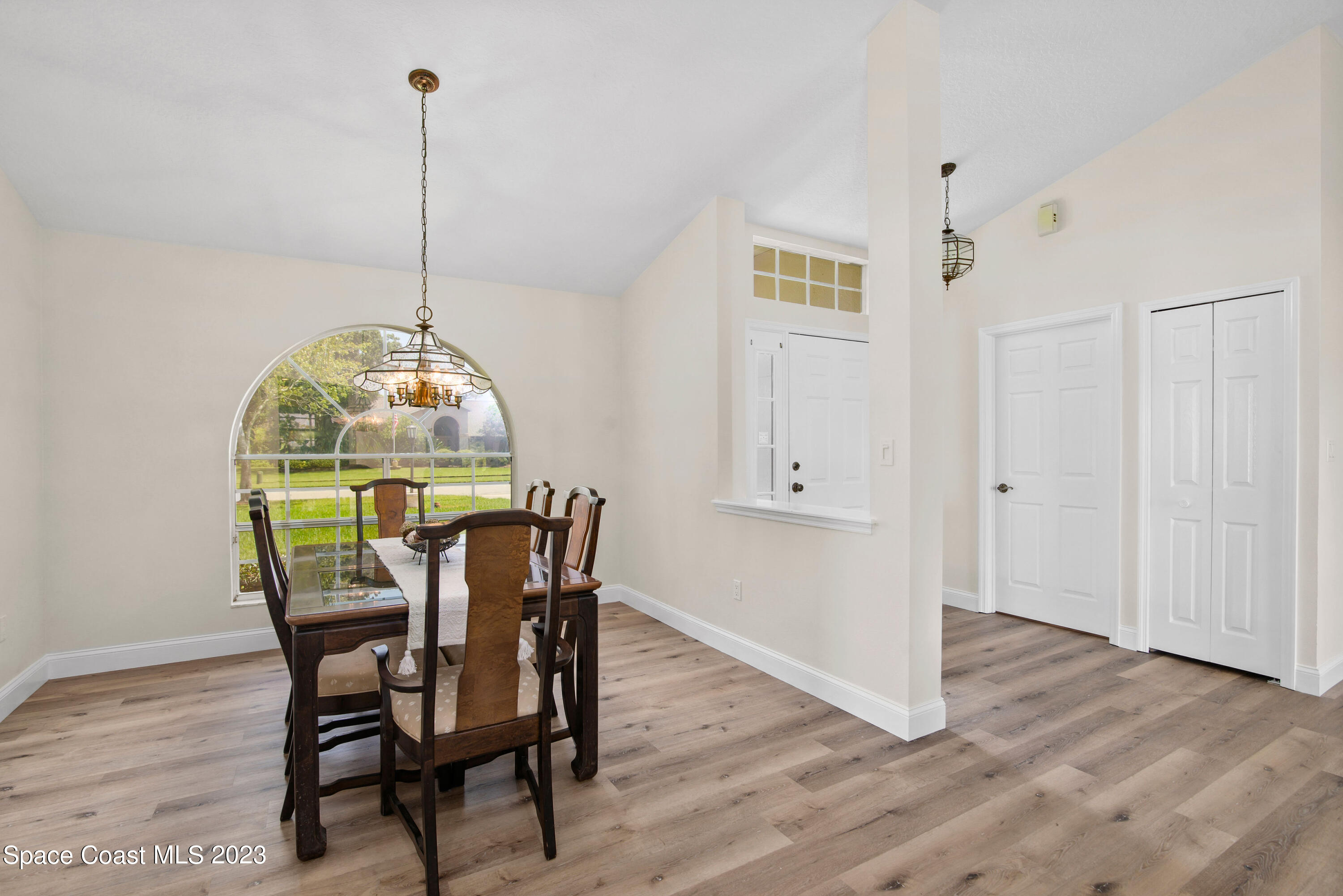3360 Holly Springs Road Melbourne, FL 32934 - Photo 18 of 42 a view of a dining room with furniture window and wooden floor