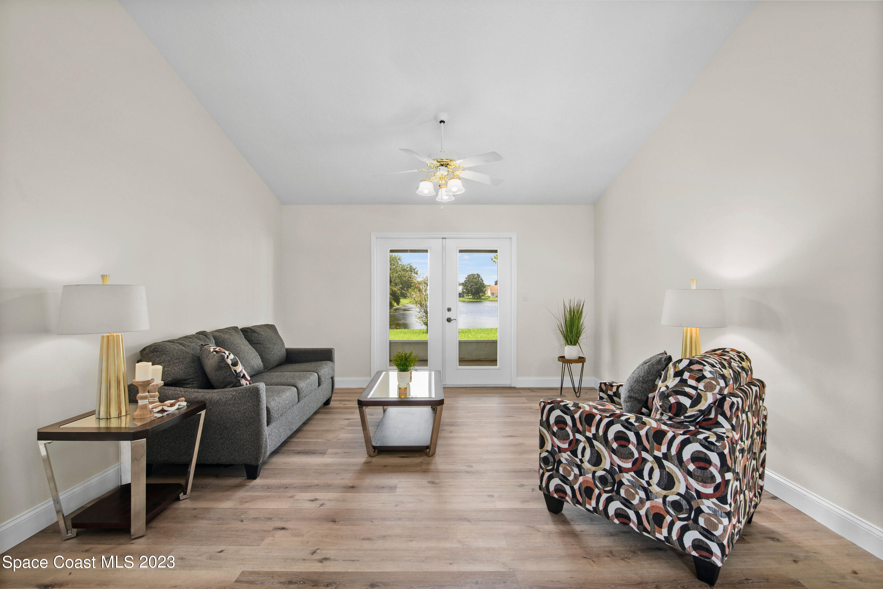 3360 Holly Springs Road Melbourne, FL 32934 - Photo 21 of 42 a living room with furniture and wooden floor