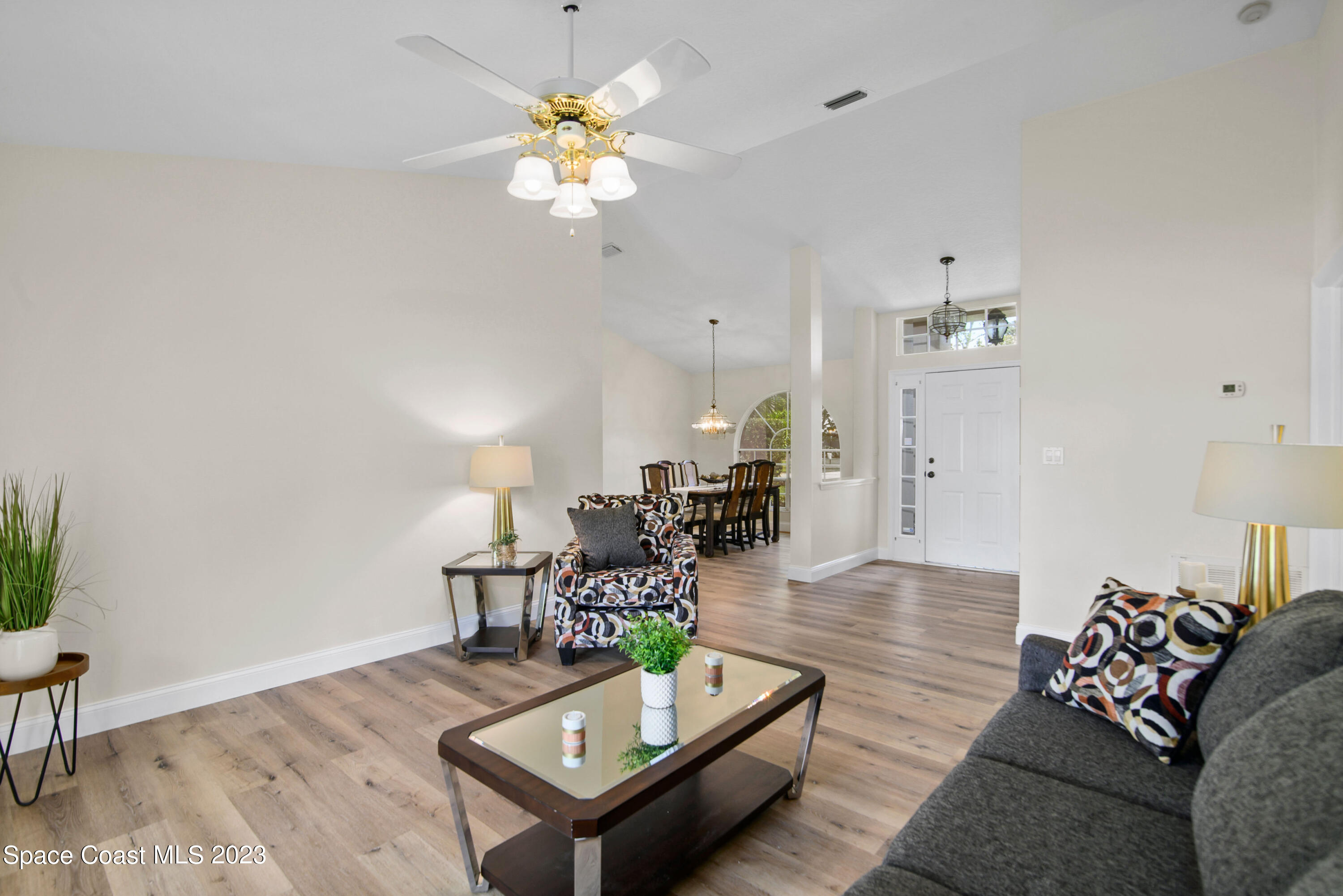 3360 Holly Springs Road Melbourne, FL 32934 - Photo 22 of 42 a living room with furniture and a wooden floor