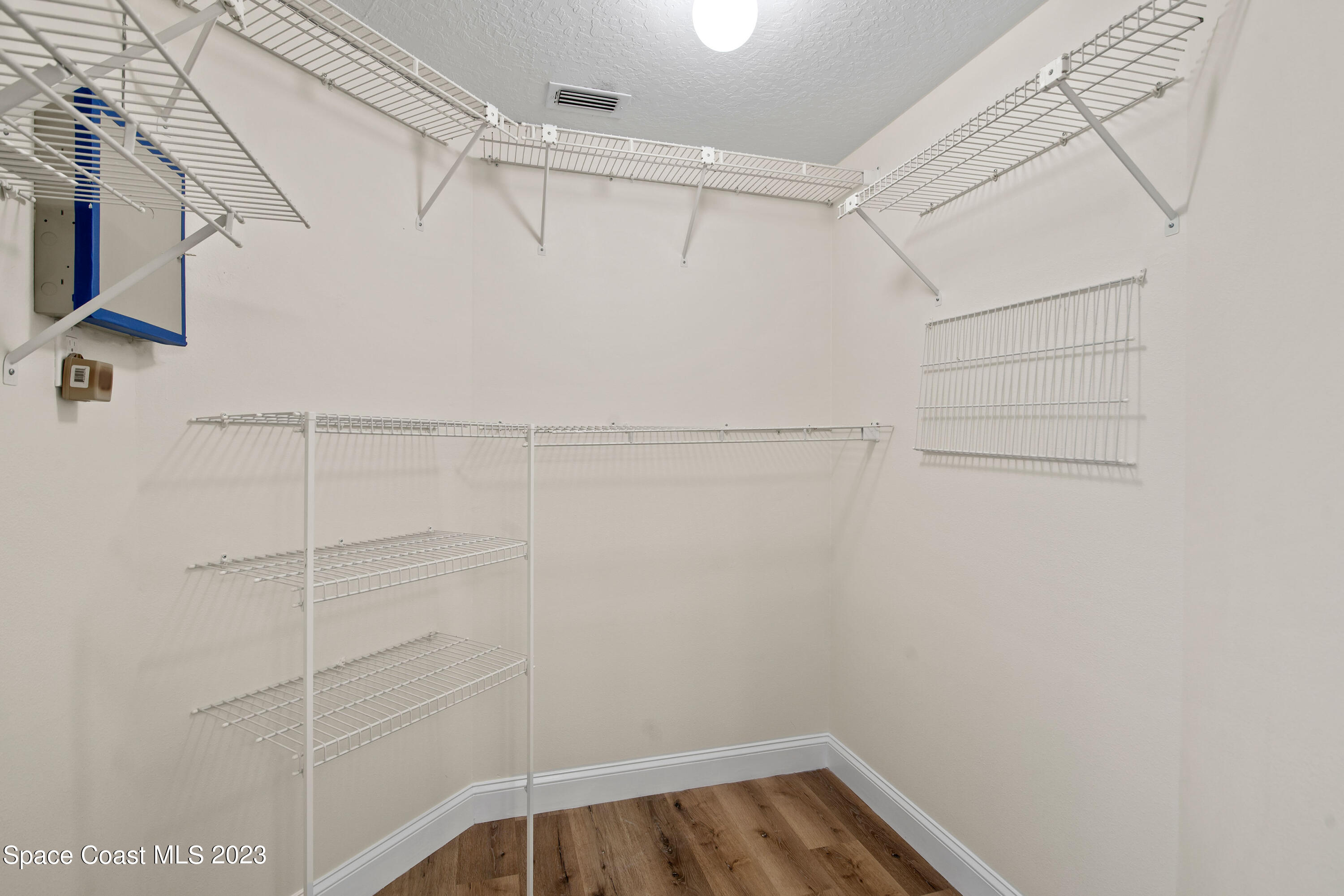 3360 Holly Springs Road Melbourne, FL 32934 - Photo 26 of 42 a view of a room with racks on the wall