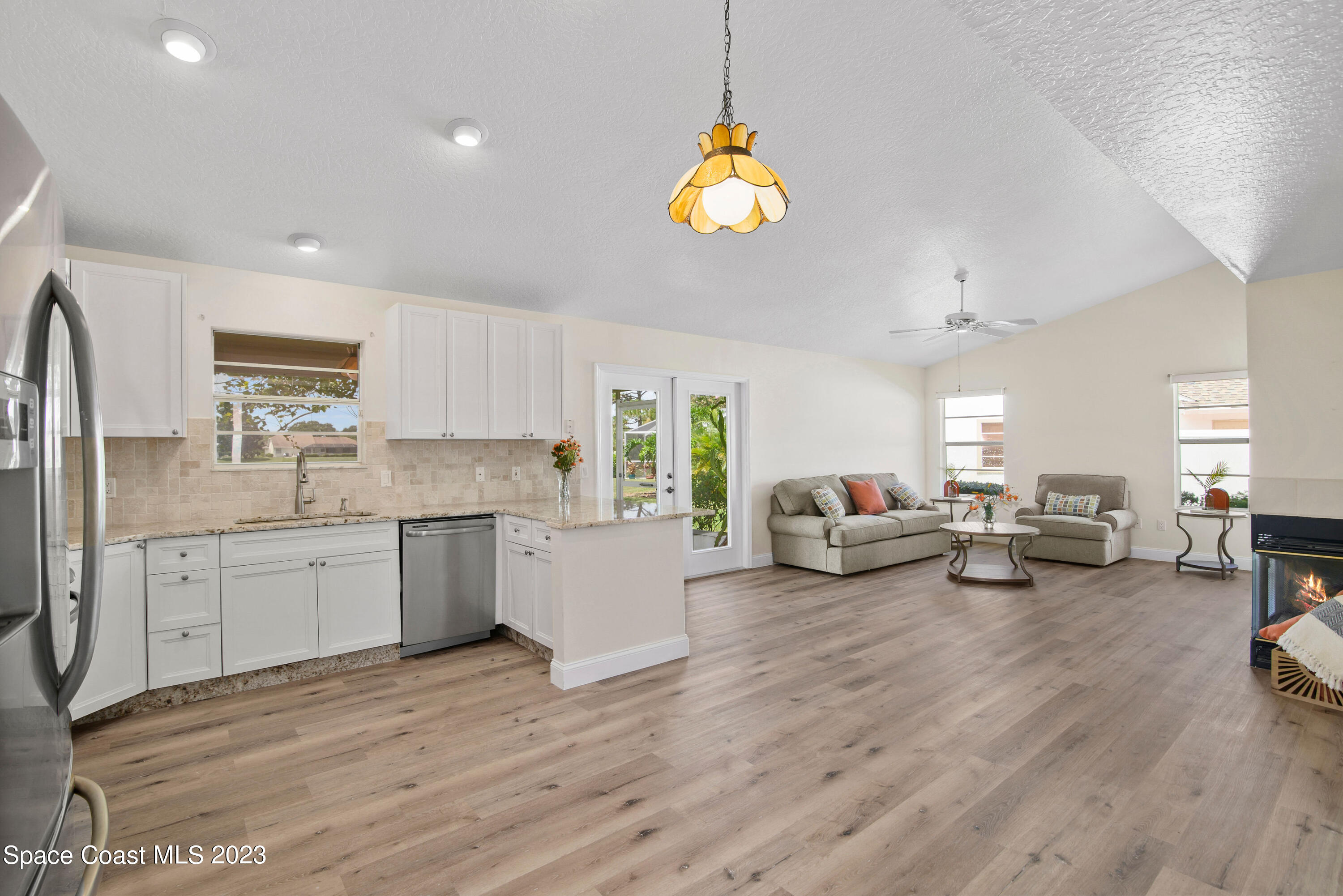 3360 Holly Springs Road Melbourne, FL 32934 - Photo 27 of 42 a living room with furniture and a wooden floor