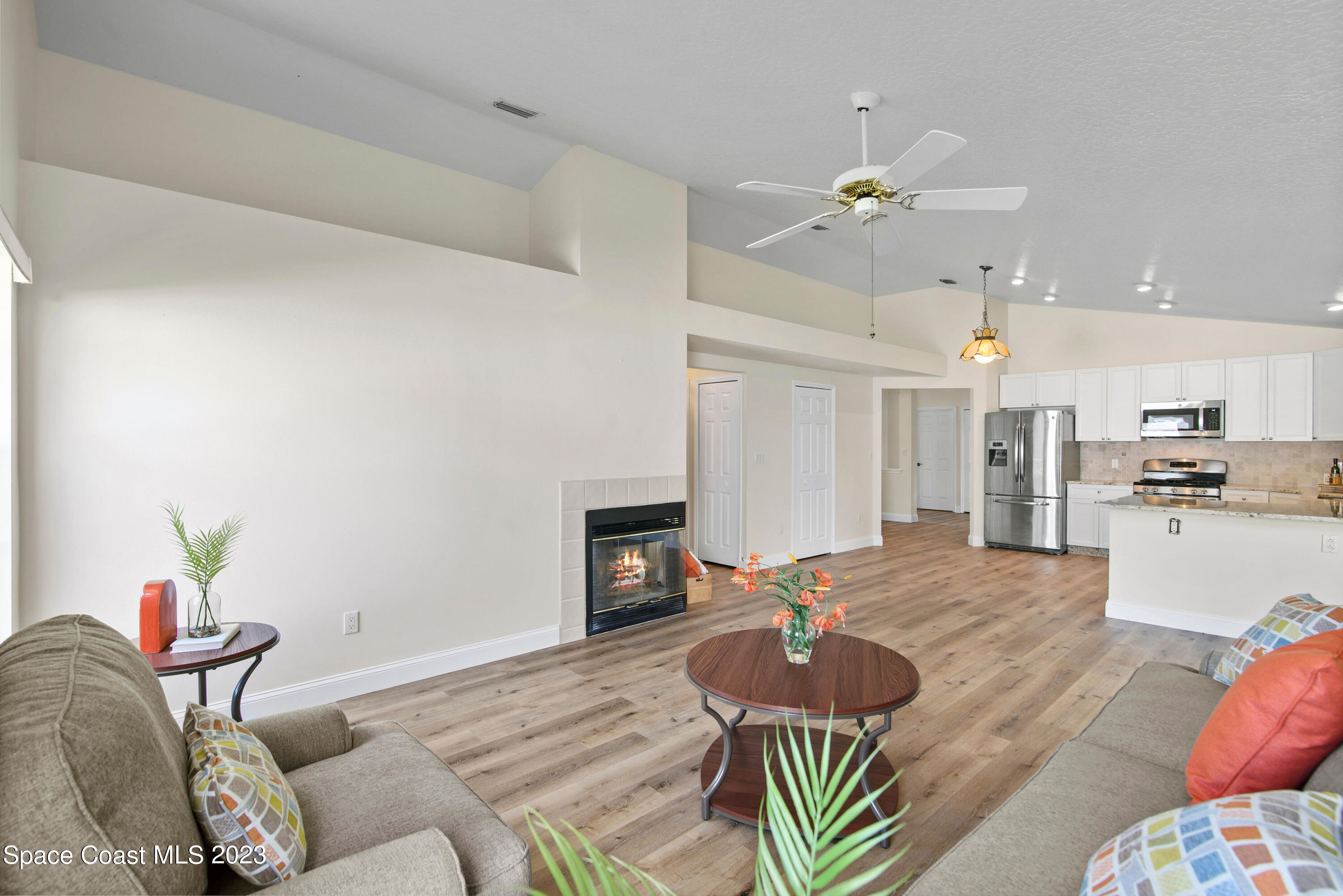 3360 Holly Springs Road Melbourne, FL 32934 - Photo 29 of 42 a living room with furniture and a fireplace