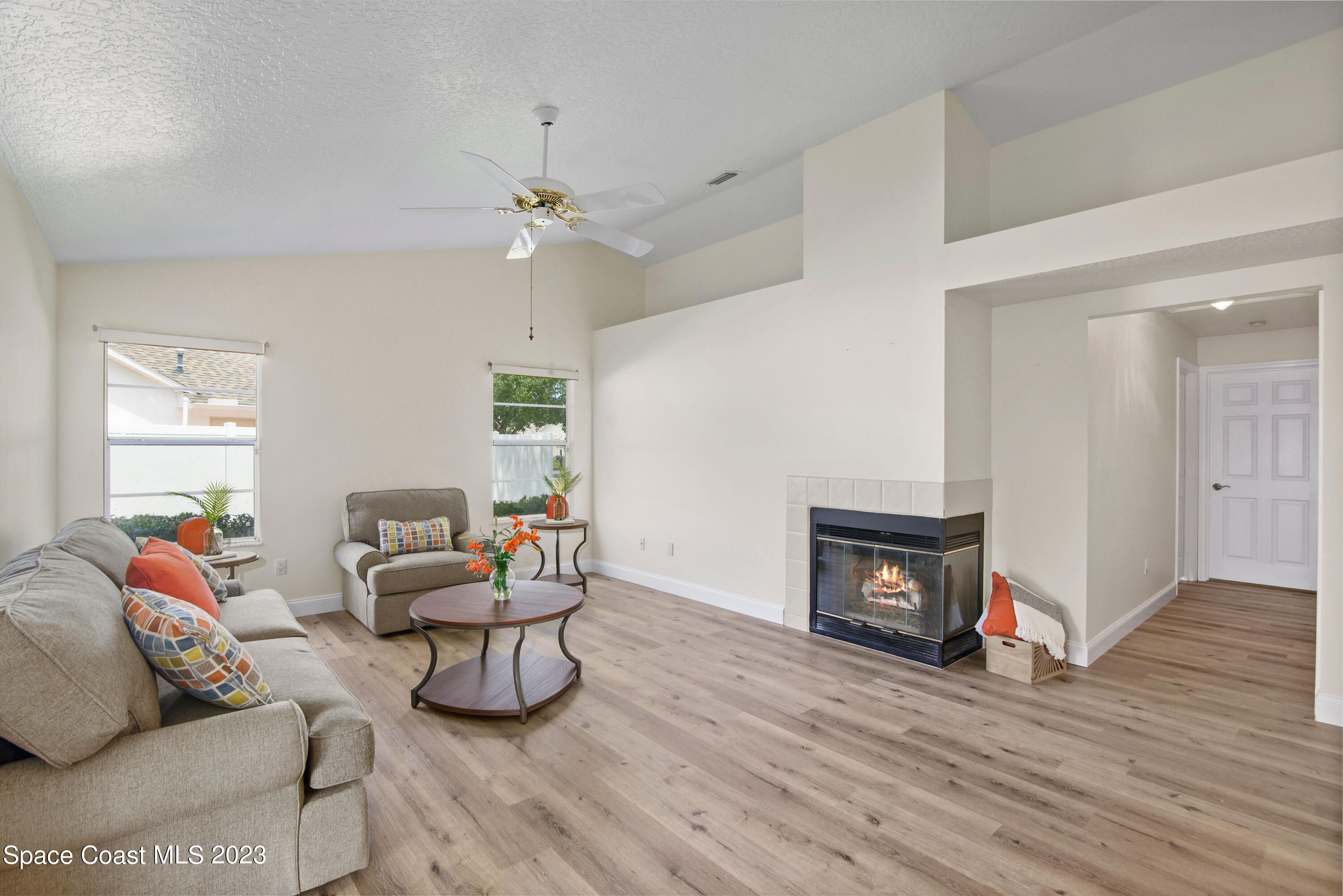 3360 Holly Springs Road Melbourne, FL 32934 - Photo 30 of 42 a living room with furniture and a fireplace