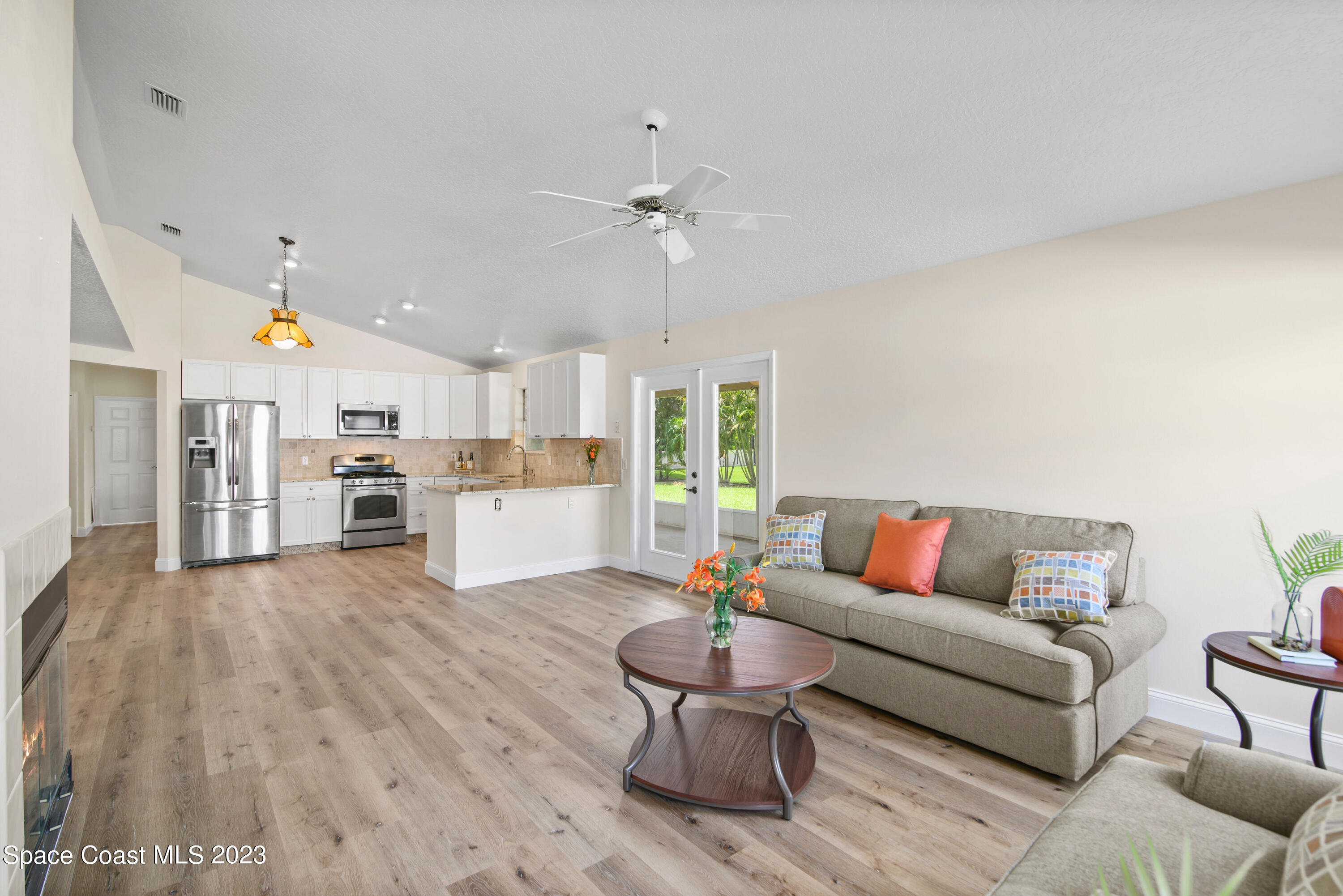 3360 Holly Springs Road Melbourne, FL 32934 - Photo 31 of 42 a living room with furniture and kitchen view