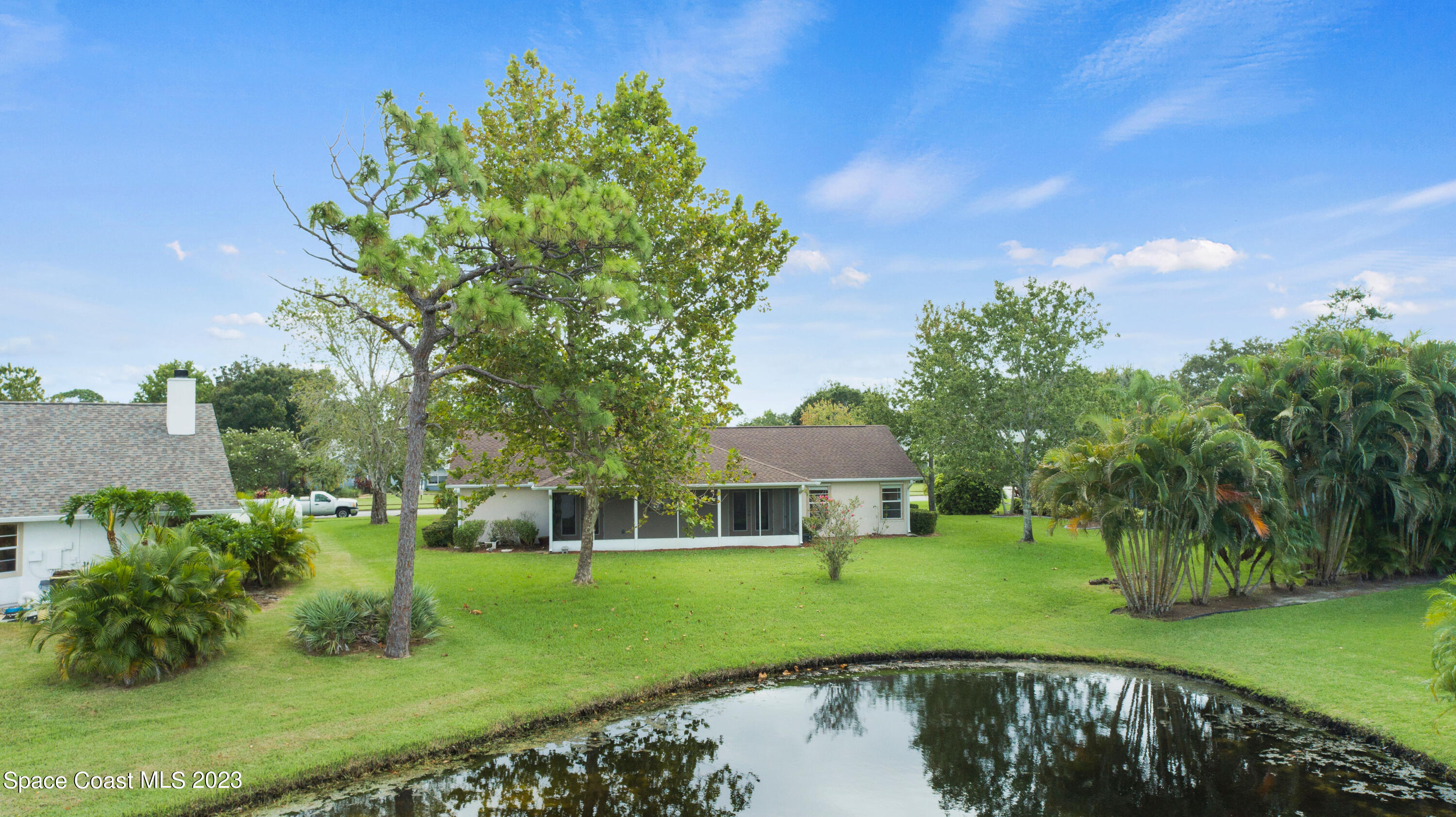 3360 Holly Springs Road Melbourne, FL 32934 - Photo 32 of 42 a view of a house with a big yard