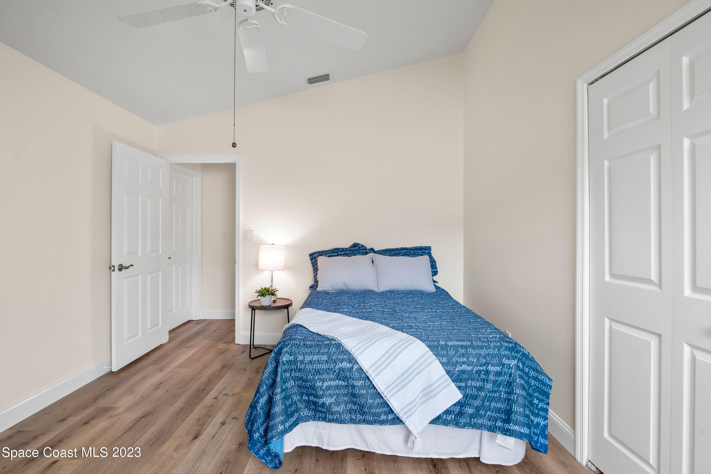 3360 Holly Springs Road Melbourne, FL 32934 - Photo 37 of 42 a bedroom with a bed and wooden floor