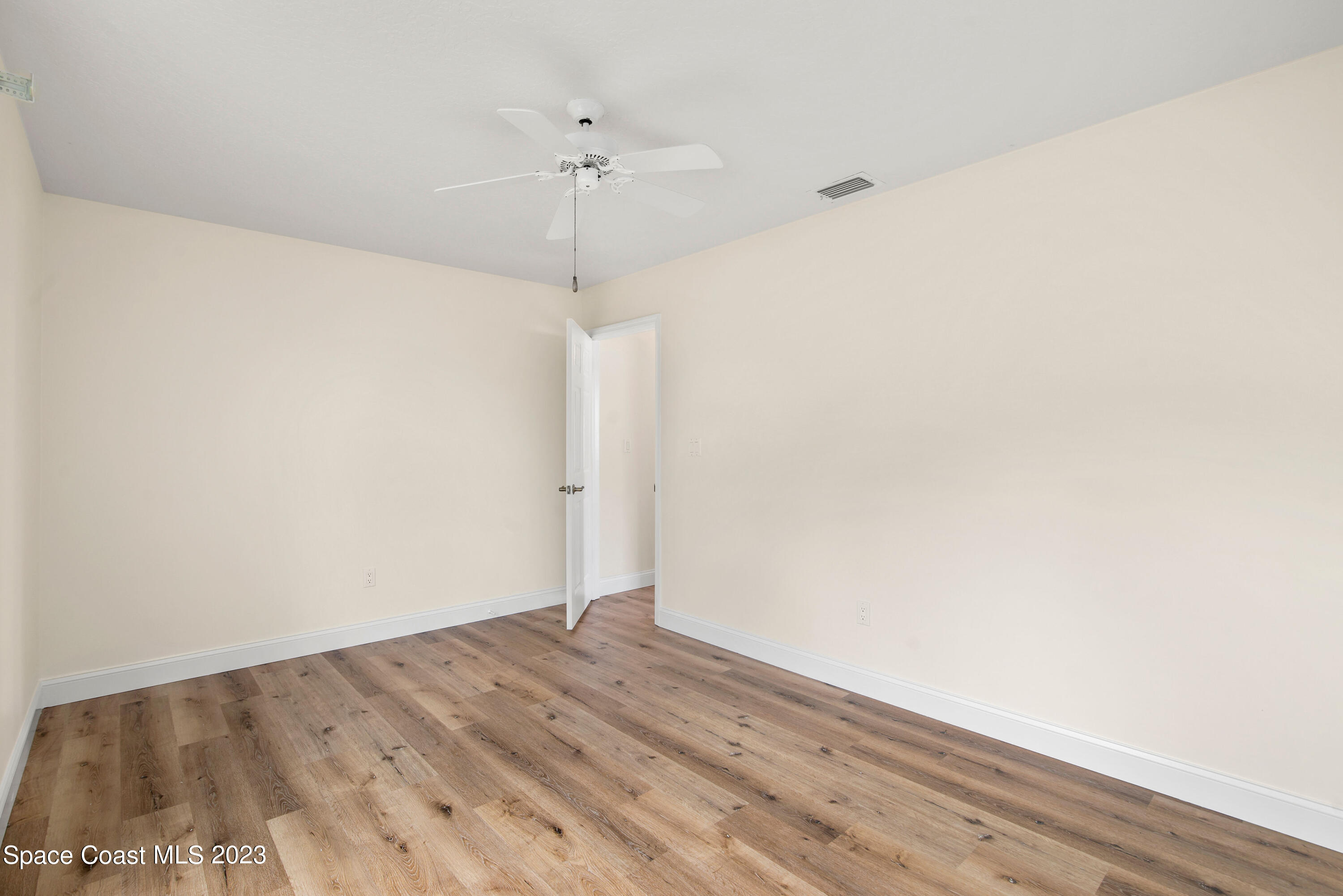 3360 Holly Springs Road Melbourne, FL 32934 - Photo 39 of 42 a view of empty room with wooden floor
