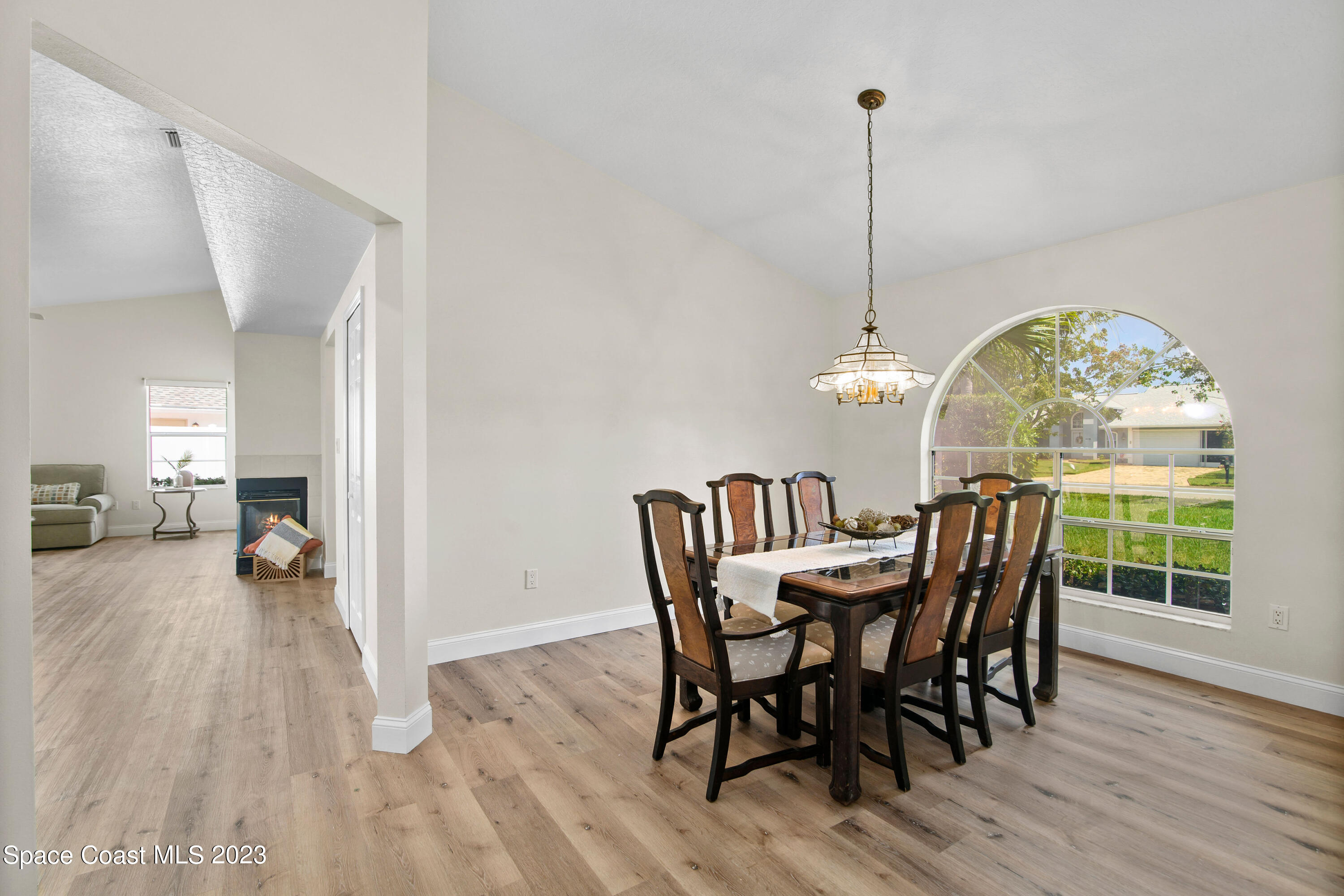 3360 Holly Springs Road Melbourne, FL 32934 - Photo 6 of 42 a view of a dining room with furniture window and wooden floor