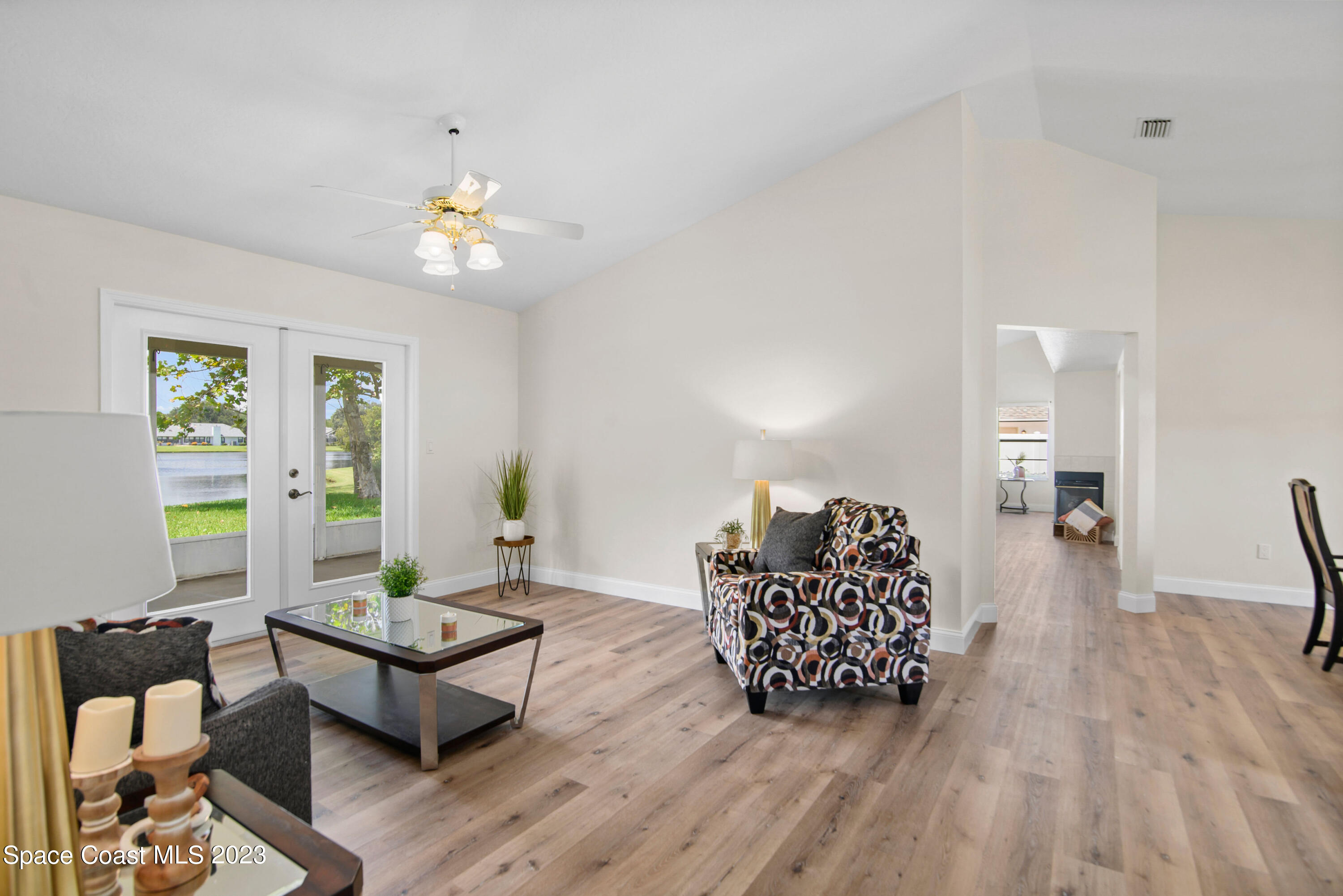 3360 Holly Springs Road Melbourne, FL 32934 - Photo 9 of 42 a living room with furniture and wooden floor