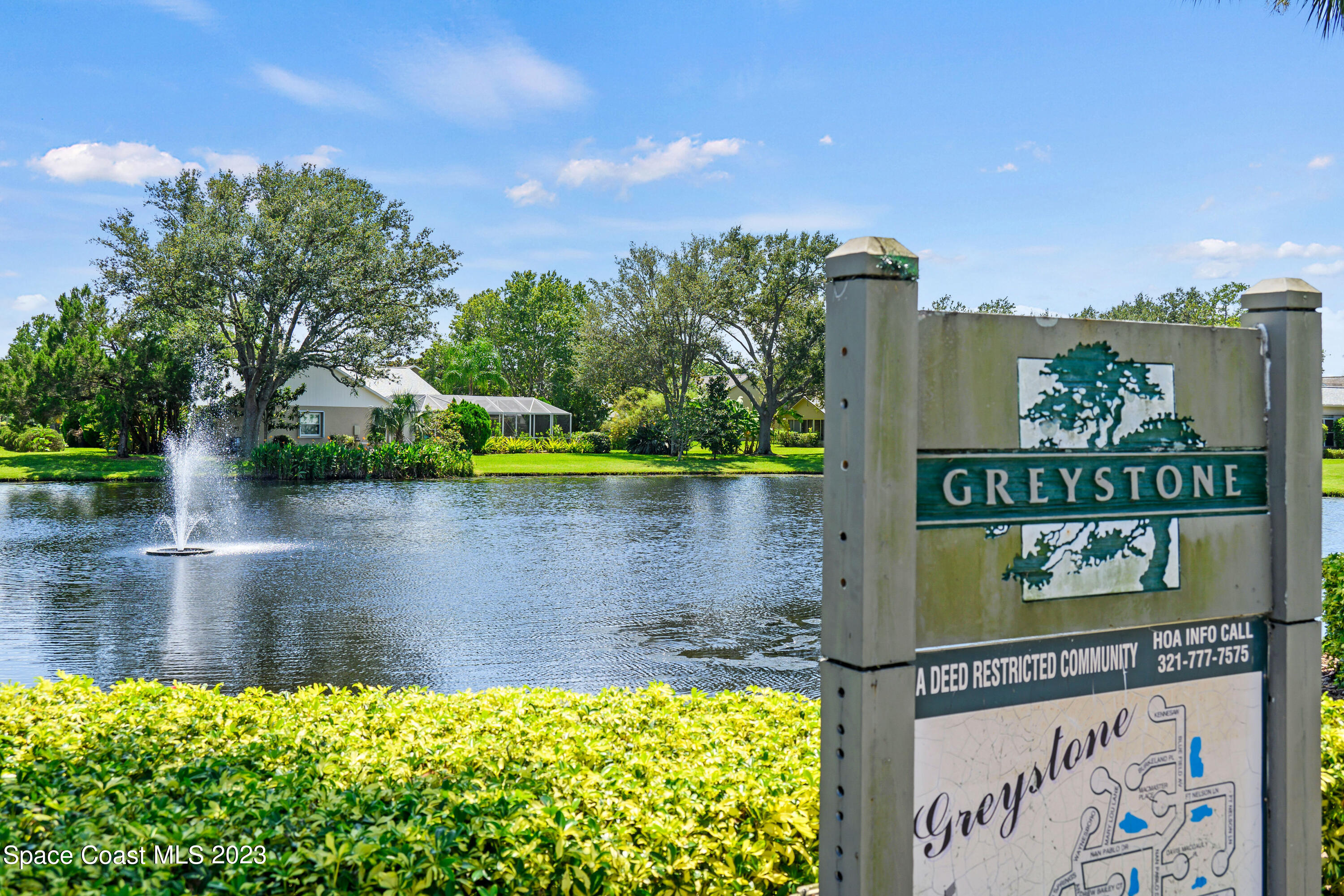 3360 Holly Springs Road Melbourne, FL 32934 - Photo 10 of 42 a view of a lake with a building in the background