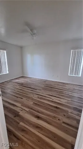 a view of a room with wooden floor