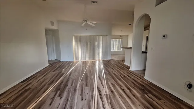 a view of a room with wooden floor and staircase