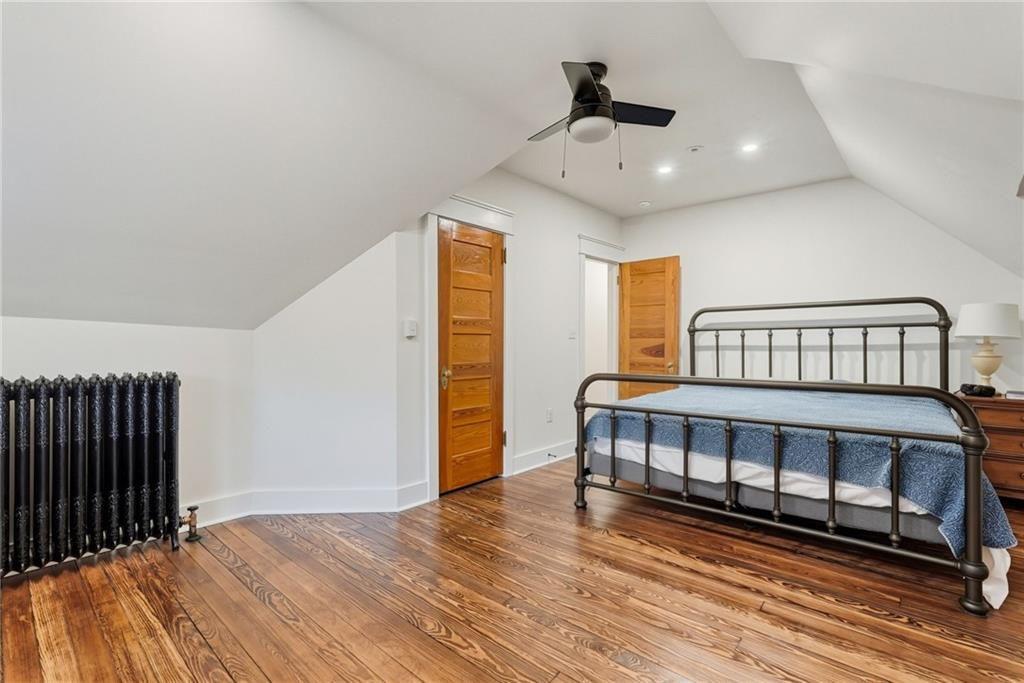 4749 Wallingford Street Pittsburgh, PA 15213 - Photo 41 of 49 a bedroom with a bed and wooden floor