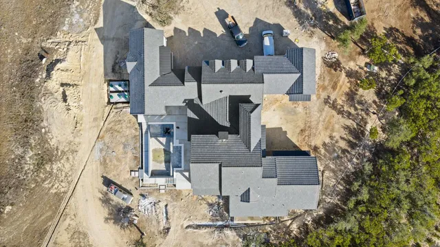 an aerial view of residential houses with outdoor space