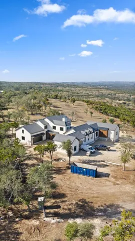 a view of a house with swimming pool and sitting area