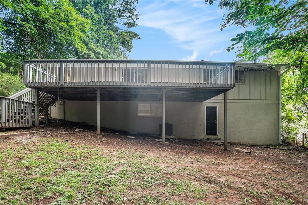 4442 Cedar Ridge Trail Stone Mountain, GA 30083 - Photo 15 of 15 a view of a house with a deck and backyard