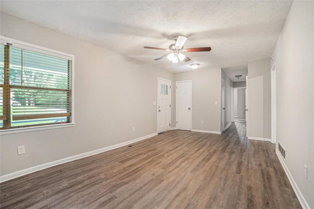 4442 Cedar Ridge Trail Stone Mountain, GA 30083 - Photo 2 of 15 wooden floor in an empty room with a window