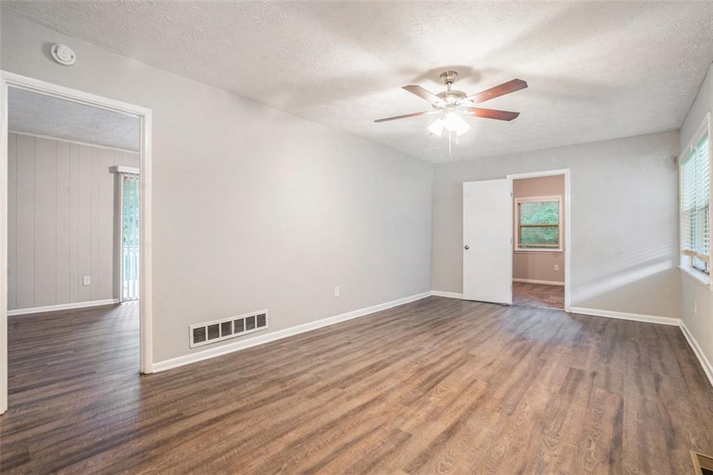 4442 Cedar Ridge Trail Stone Mountain, GA 30083 - Photo 3 of 15 a view of an empty room with wooden floor and a ceiling fan
