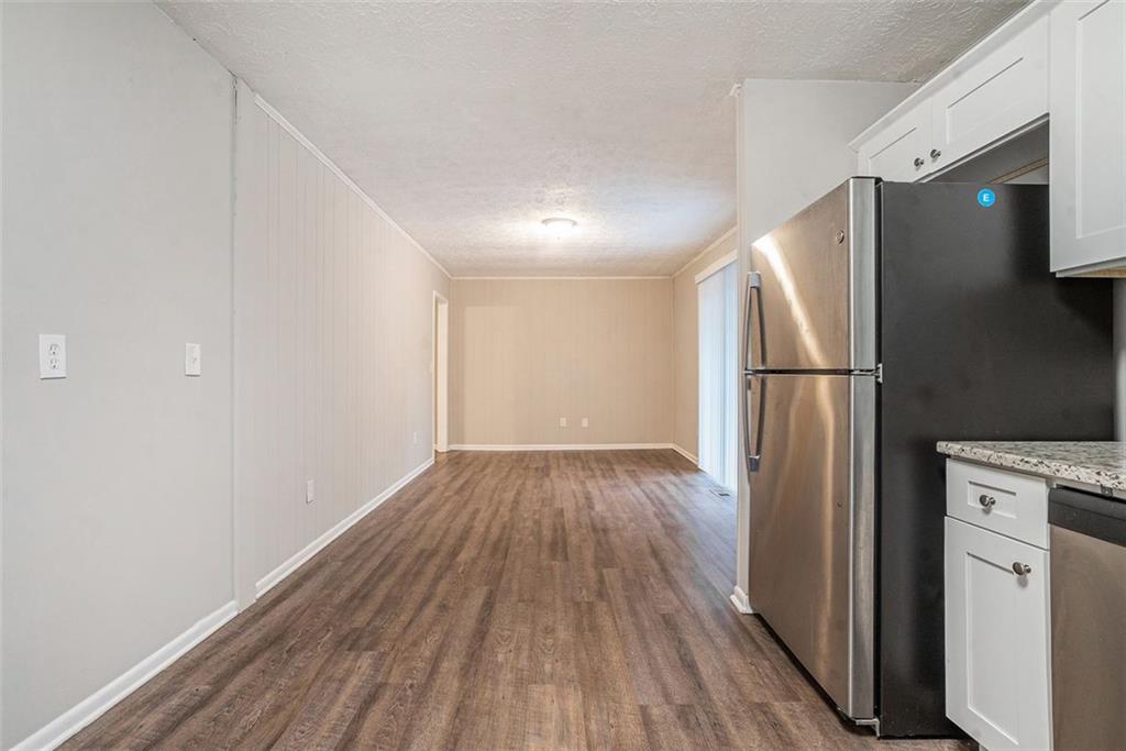 4442 Cedar Ridge Trail Stone Mountain, GA 30083 - Photo 5 of 15 a view of a kitchen with wooden floor electronic appliances and a window