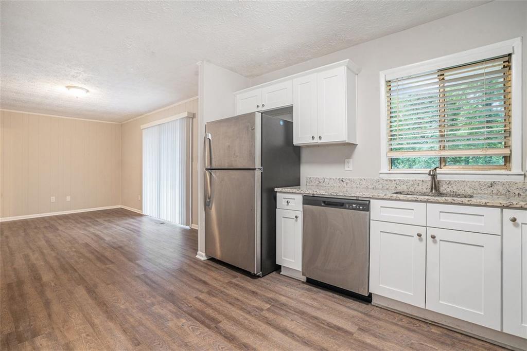 4442 Cedar Ridge Trail Stone Mountain, GA 30083 - Photo 6 of 15 a kitchen with a refrigerator sink and cabinets