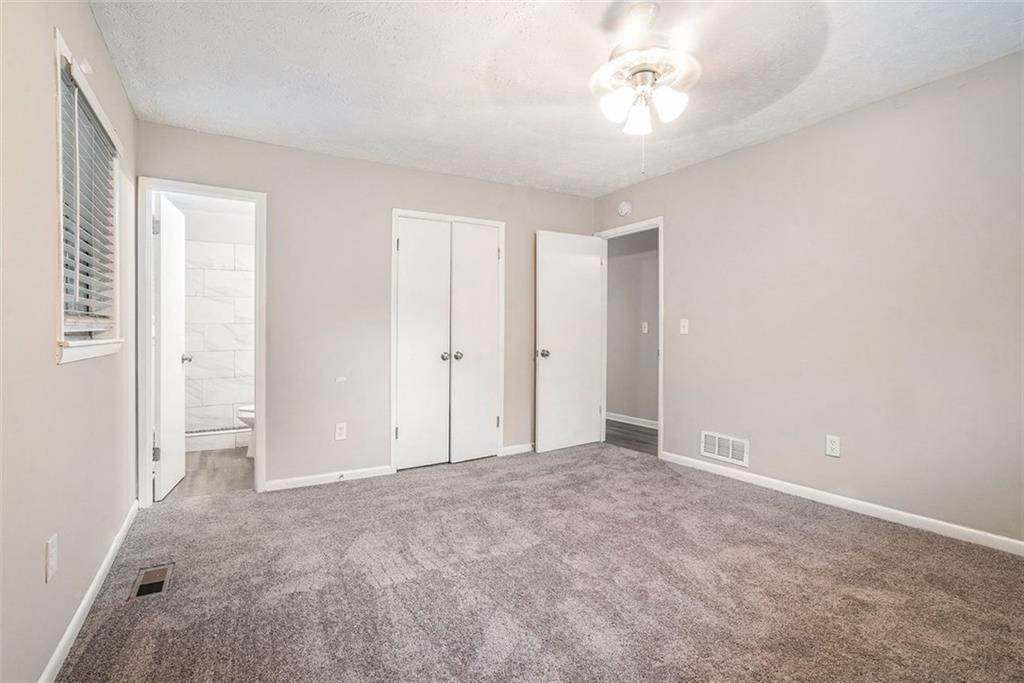 4442 Cedar Ridge Trail Stone Mountain, GA 30083 - Photo 8 of 15 a view of an empty room with a ceiling fan