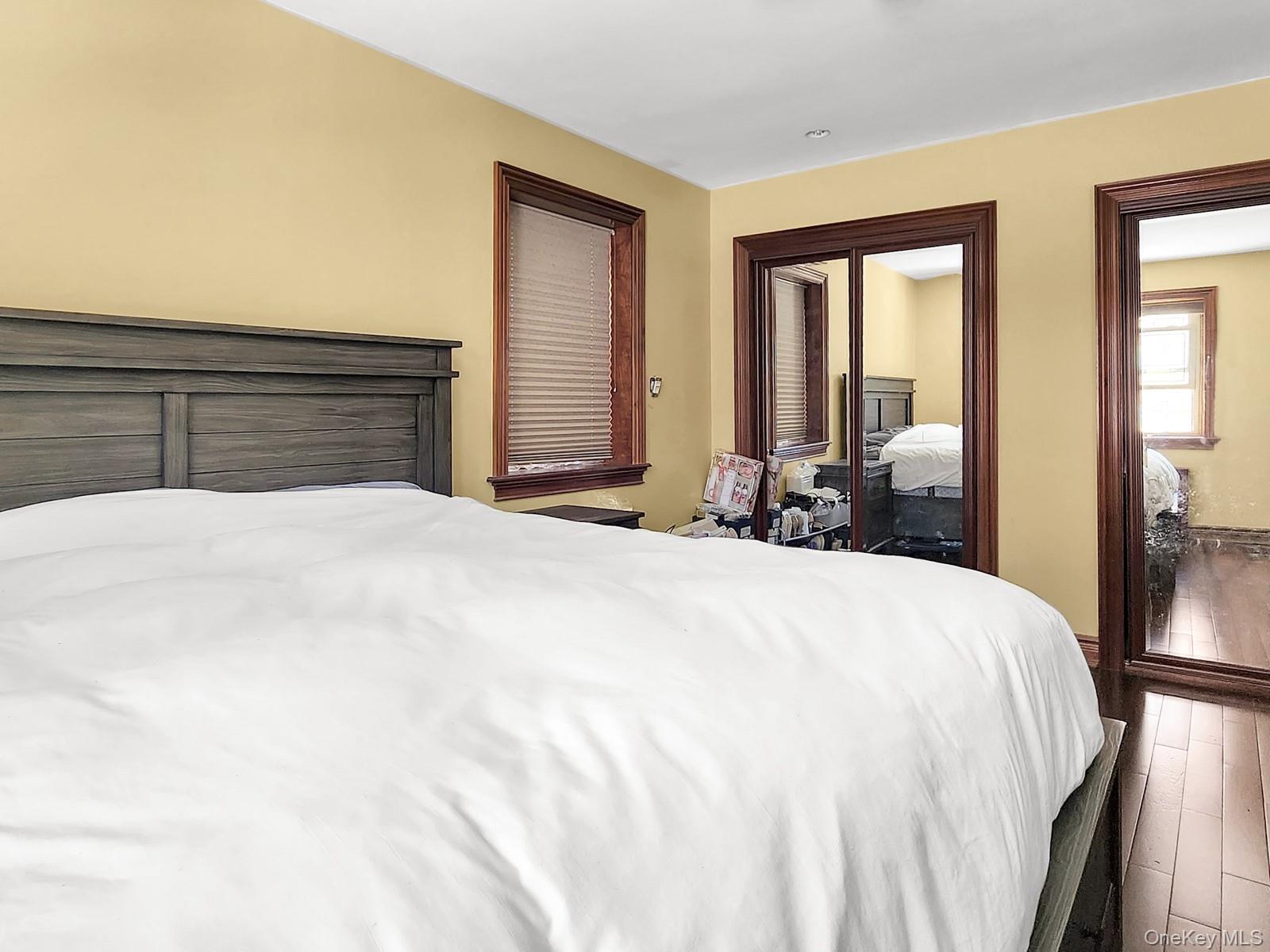 66-10 149th Street, Unit 1A Queens, NY 11367 - Photo 7 of 10 a large white bed in a white room