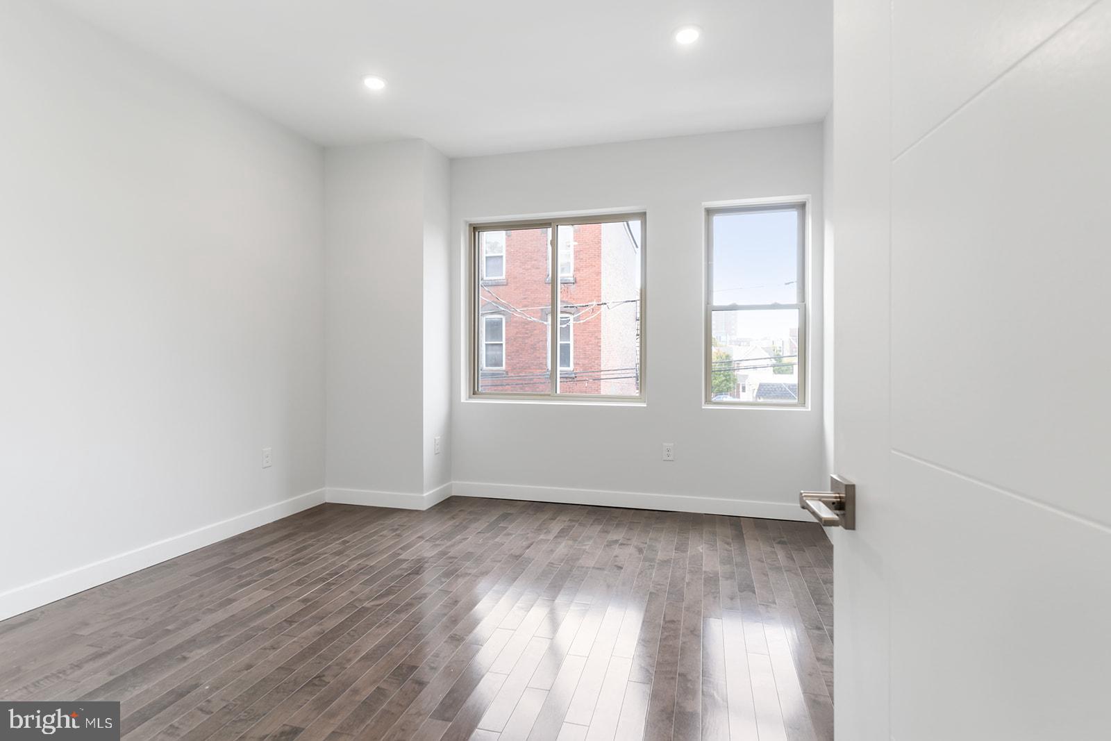 1947 North 7th Street, Unit 2 Philadelphia, PA 19122 - Photo 14 of 31 an empty room with wooden floor and windows
