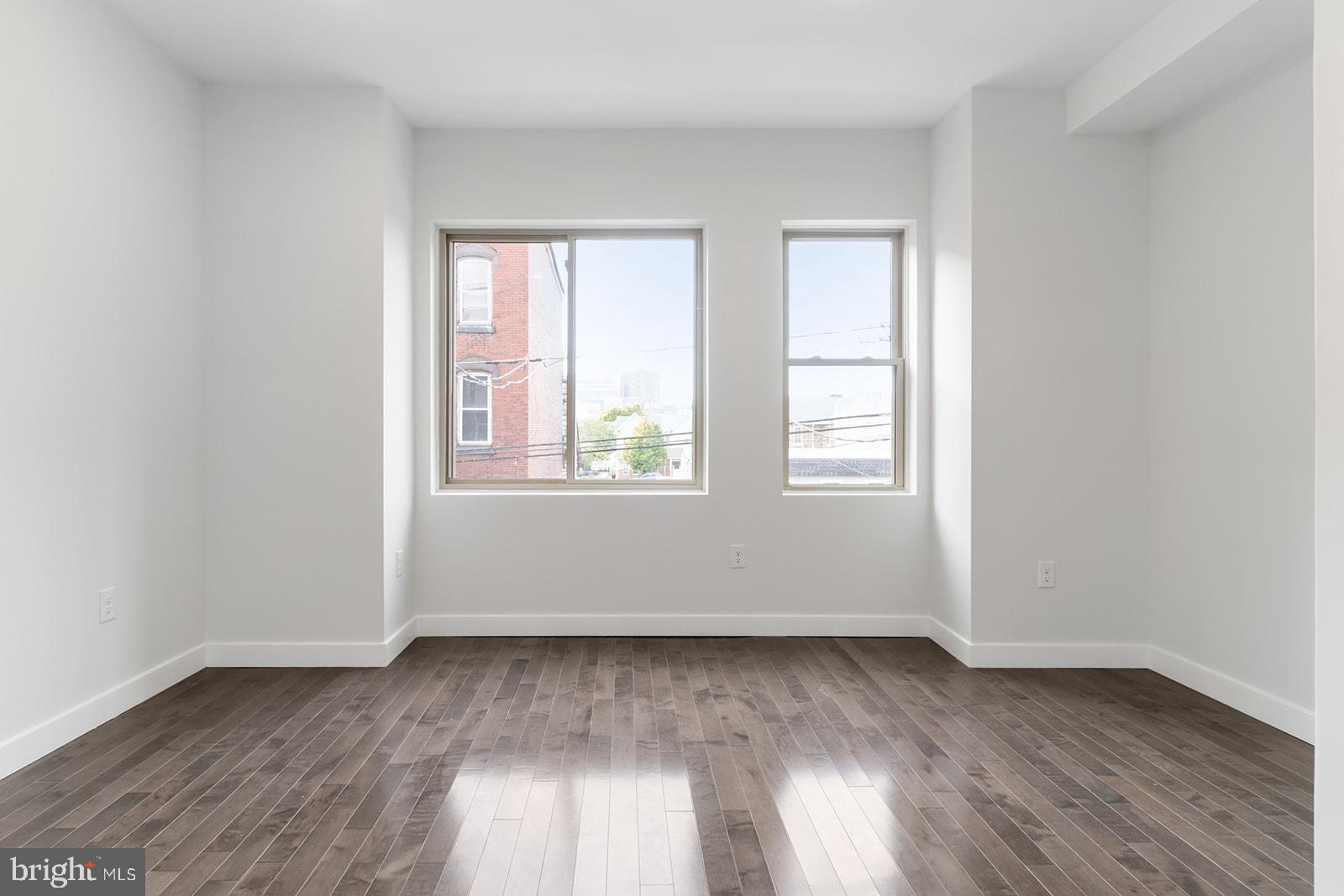 1947 North 7th Street, Unit 2 Philadelphia, PA 19122 - Photo 15 of 31 an empty room with wooden floor and windows