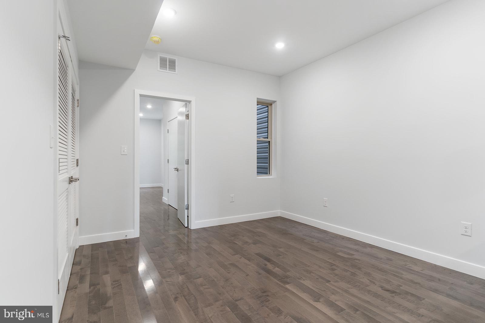1947 North 7th Street, Unit 2 Philadelphia, PA 19122 - Photo 18 of 31 an empty room with wooden floor and windows