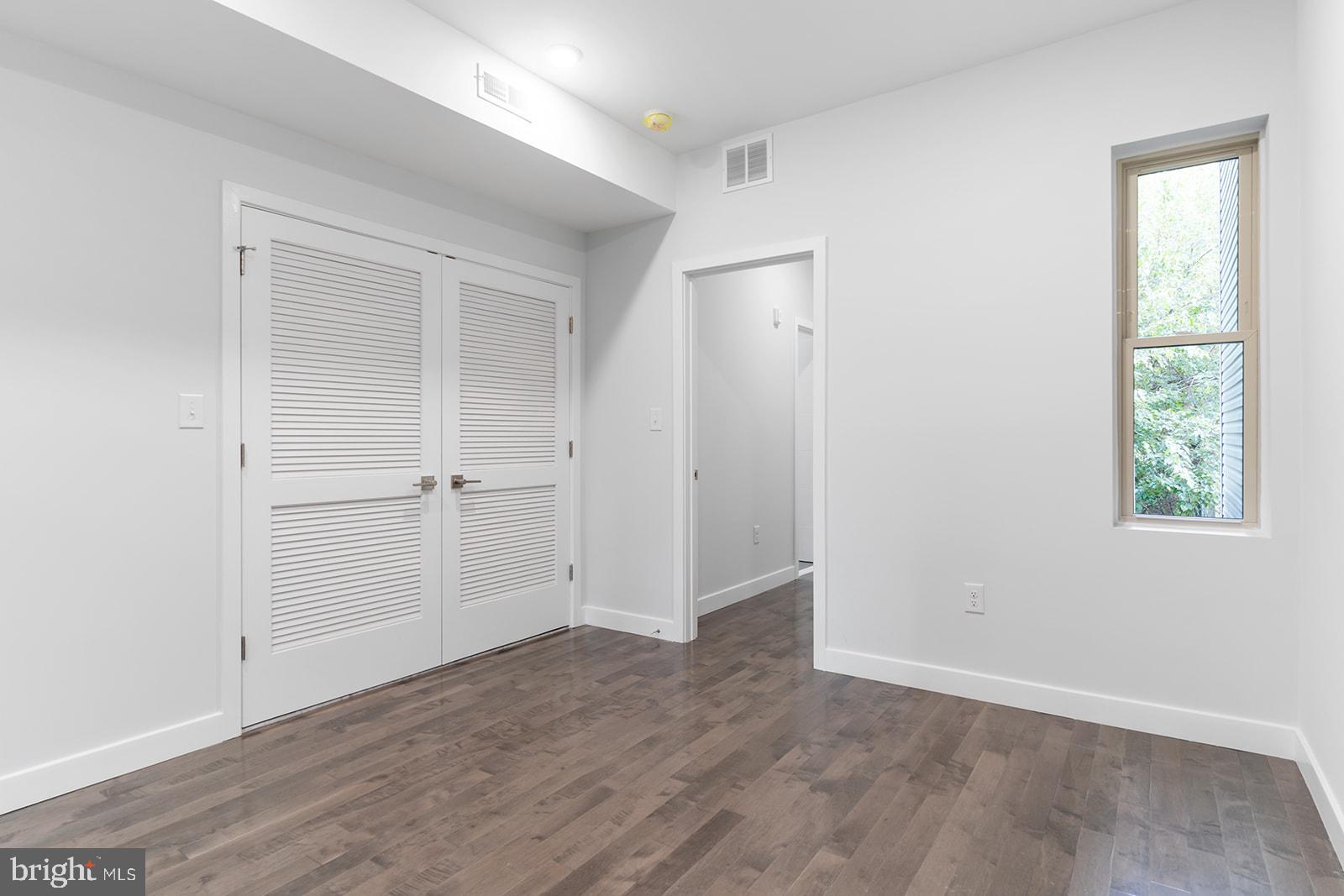 1947 North 7th Street, Unit 2 Philadelphia, PA 19122 - Photo 19 of 31 an empty room with wooden floor closet and windows