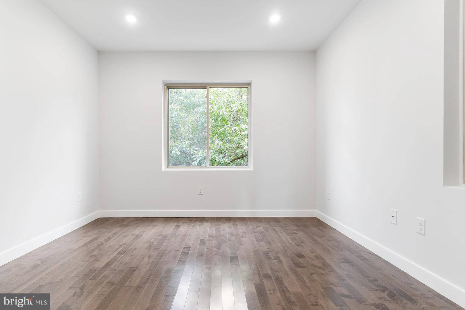 1947 North 7th Street, Unit 2 Philadelphia, PA 19122 - Photo 25 of 31 an empty room with wooden floor and windows