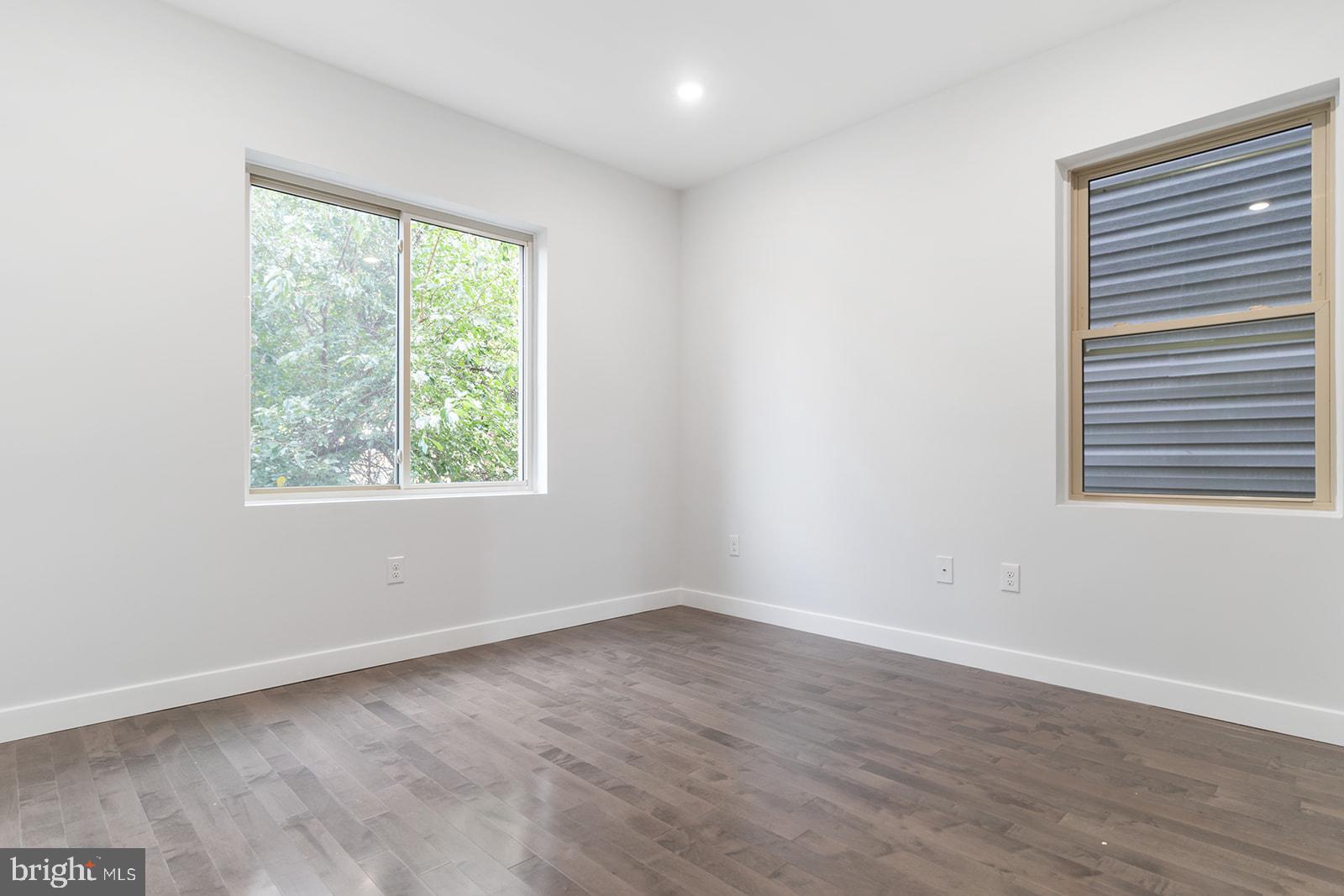 1947 North 7th Street, Unit 2 Philadelphia, PA 19122 - Photo 26 of 31 an empty room with wooden floor and windows