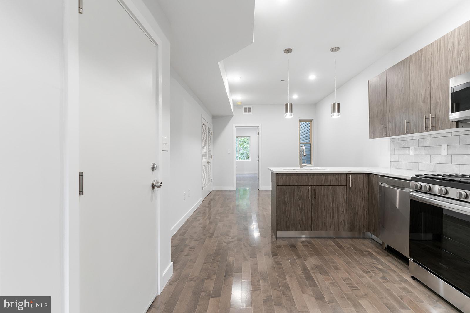 1947 North 7th Street, Unit 2 Philadelphia, PA 19122 - Photo 3 of 31 a view of a kitchen with a sink and a stove top oven