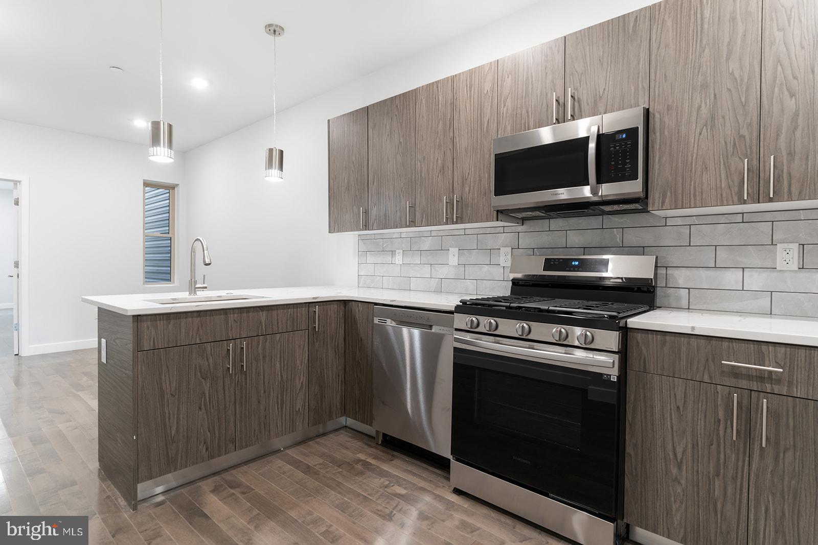 1947 North 7th Street, Unit 2 Philadelphia, PA 19122 - Photo 9 of 31 a kitchen with a sink stove and microwave