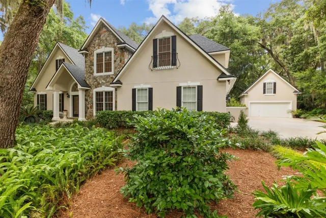 a kitchen with stainless steel appliances granite countertop a sink refrigerator and cabinets