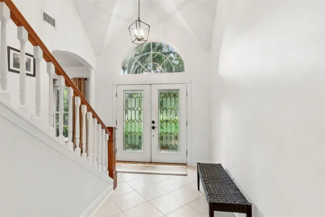 a spacious bathroom with a double vanity sink and a mirror