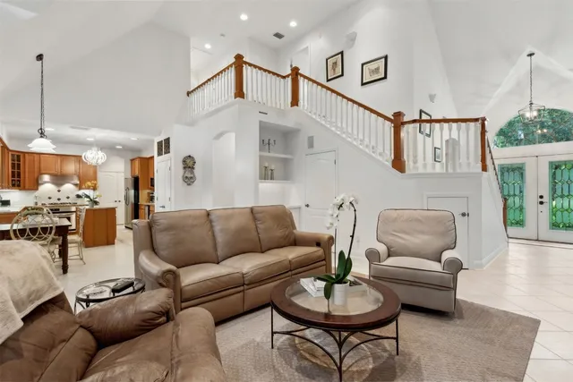 a view of a livingroom with a furniture ceiling fan and floor to ceiling window