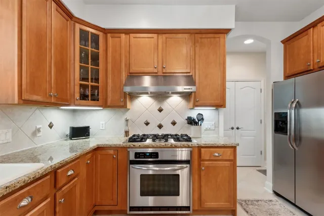 a white house with a yard and large trees