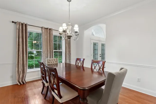 a white house with a large tree in front of it